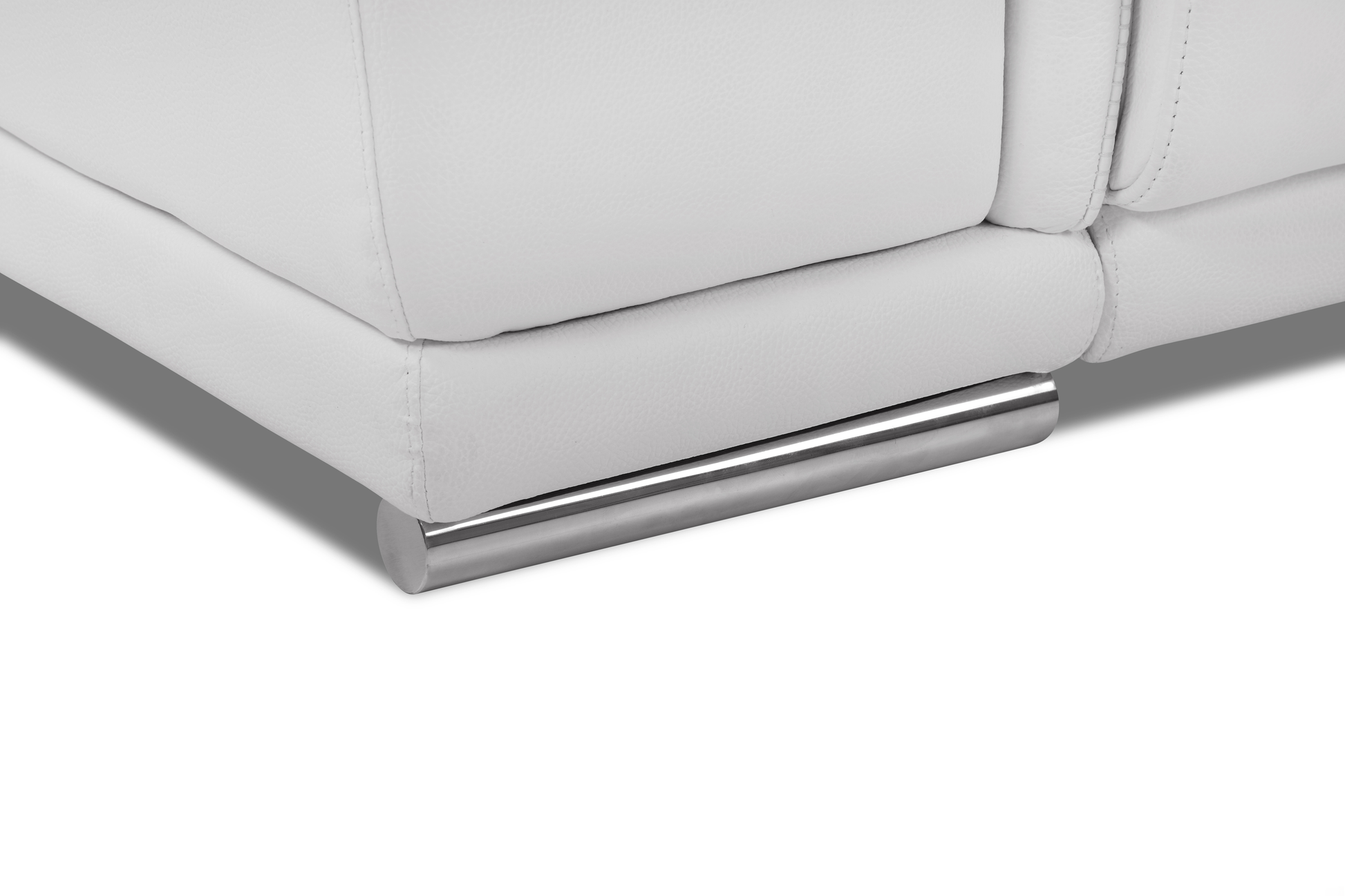 Closeup of a white faux leather sofa base with a polished chrome cylindrical leg