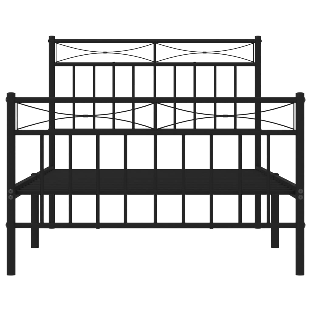 Black metal bed frame with decorative scrollwork and a white mattress