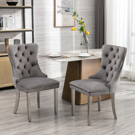 Elegant grey velvet dining chairs with tufted back and silver nailhead trim