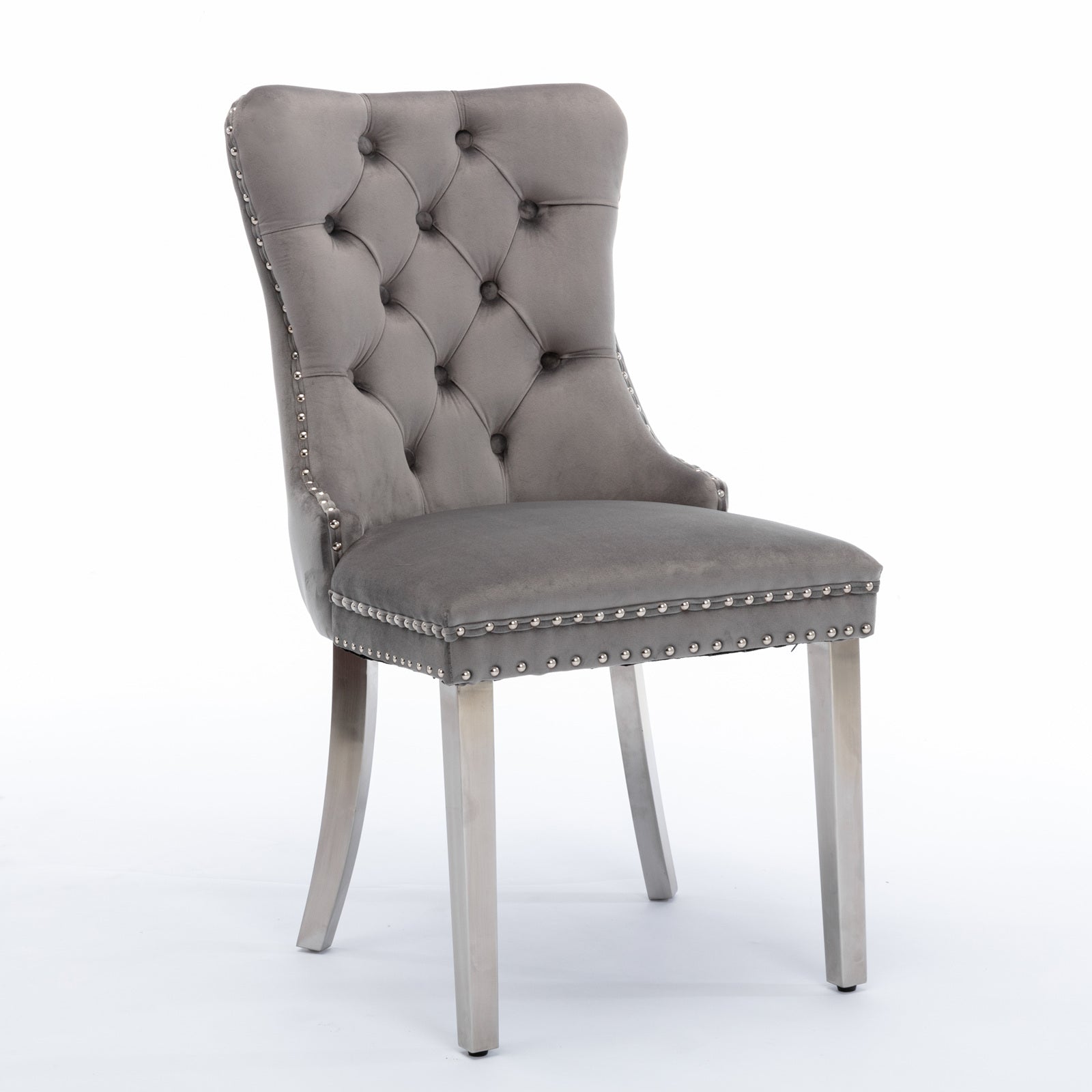 Grey velvet dining chair with tufted back and silver nailhead trim