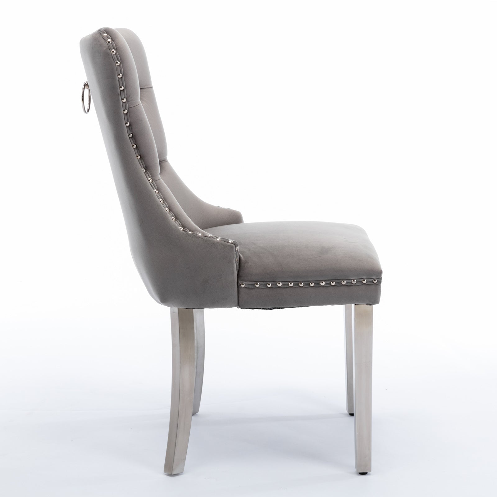 Gray velvet dining chair with tufted back and silver nailhead trim
