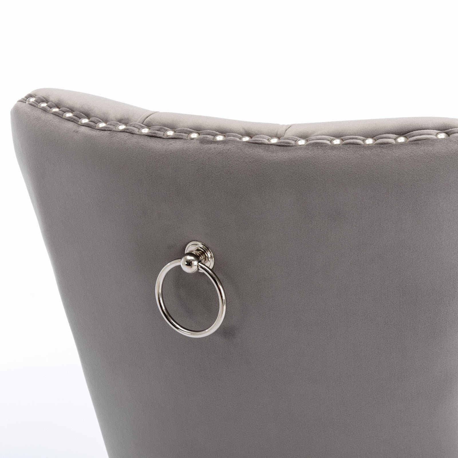 Grey velvet dining chair with studded trim and silver ring pull