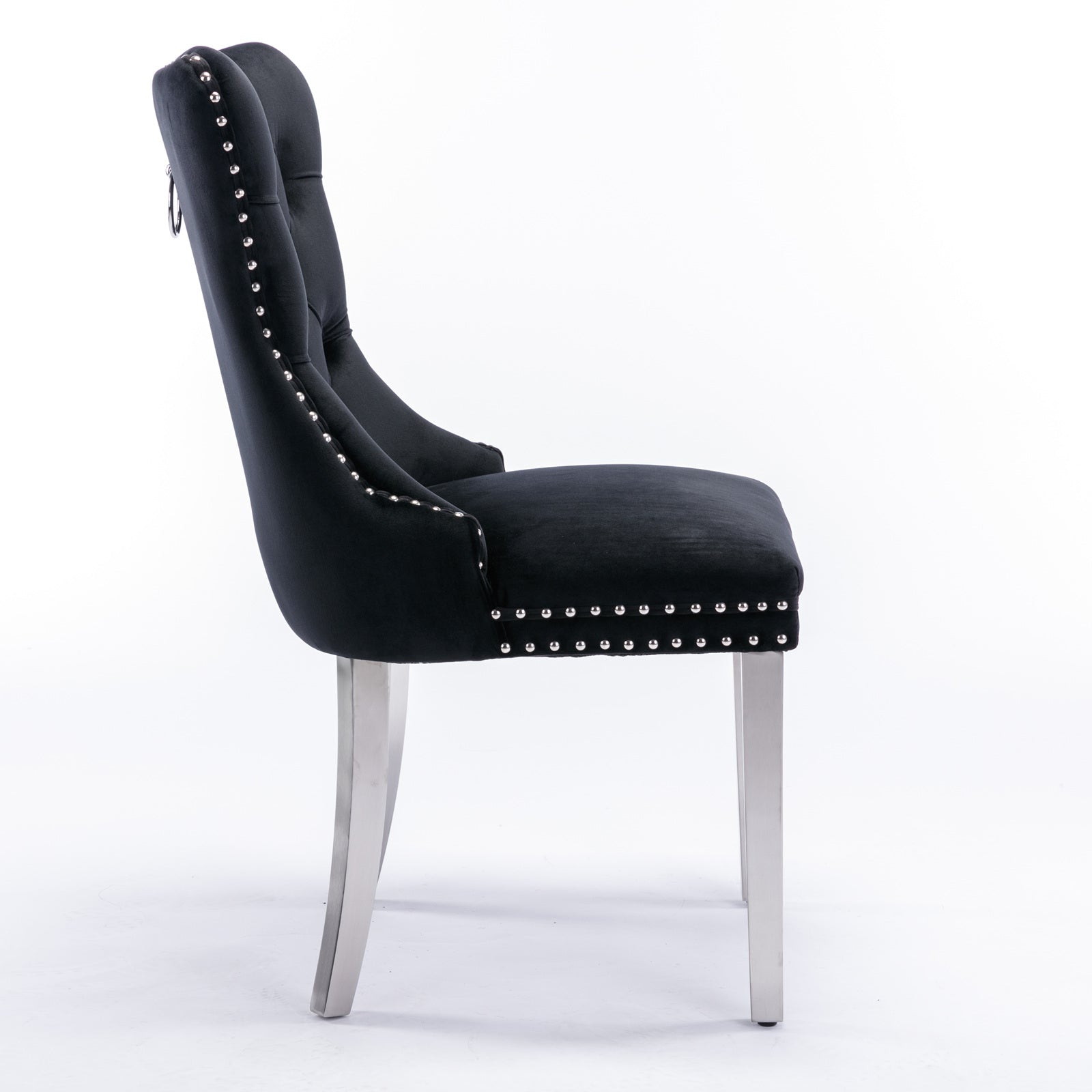 Black velvet dining chair with silver stud accents and a pull ring