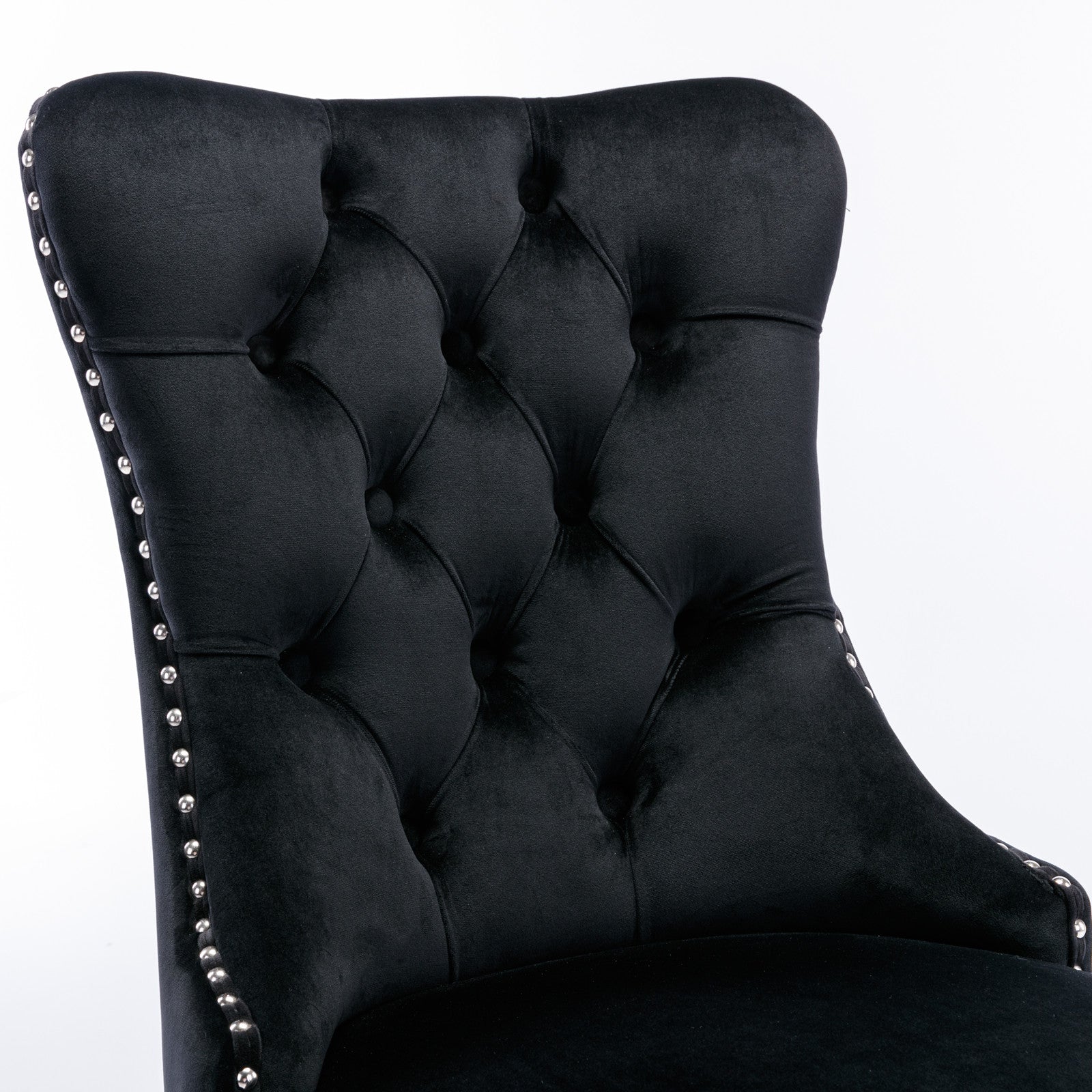 Black velvet tufted accent chair with silver nailhead trim