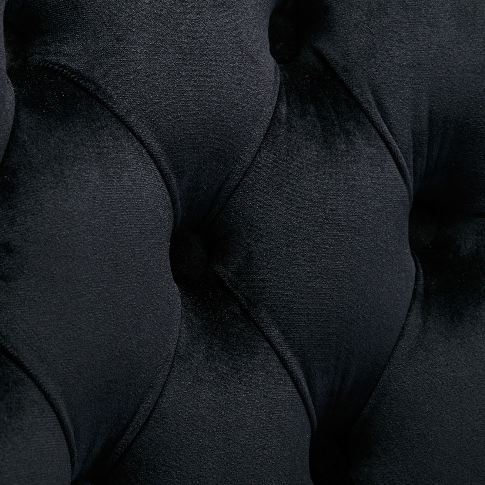 Closeup of black velvet tufted upholstery fabric