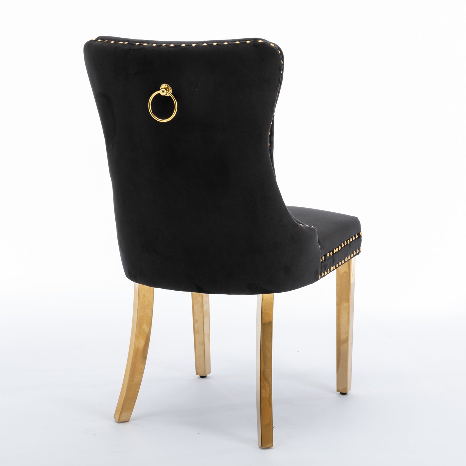 Black velvet dining chair with gold studding and brass ring pull