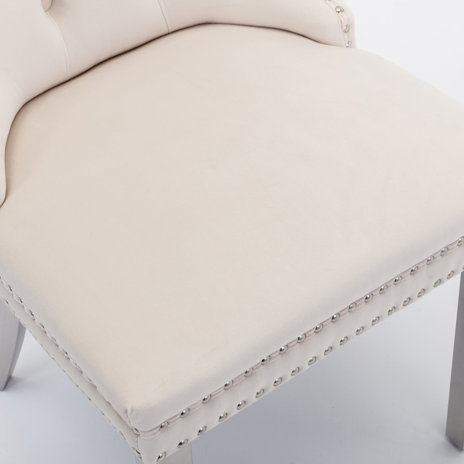 Cream velvet accent chair with diamond tufting and silver nailhead trim