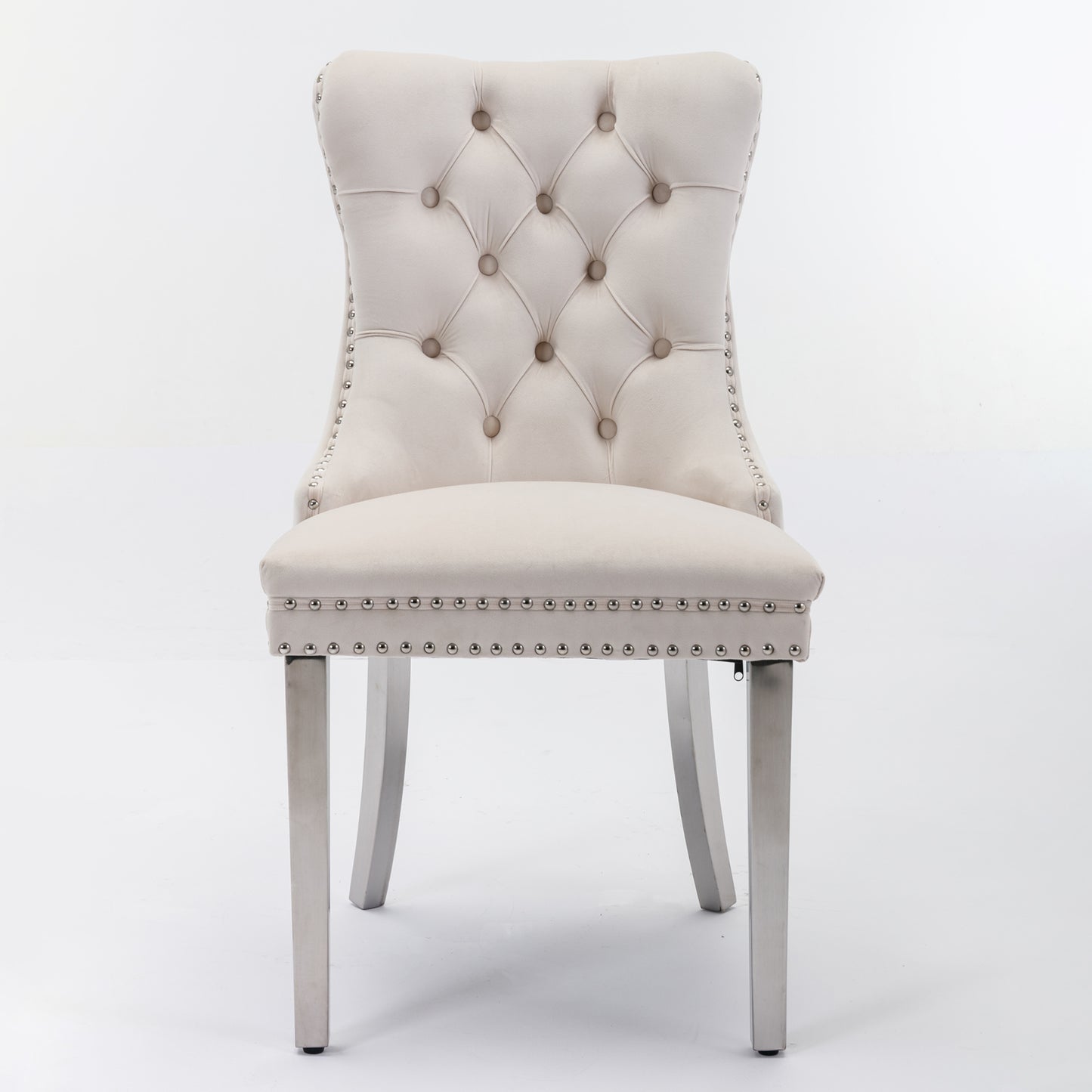 Tufted beige velvet dining chair with silver nailhead trim and metal legs