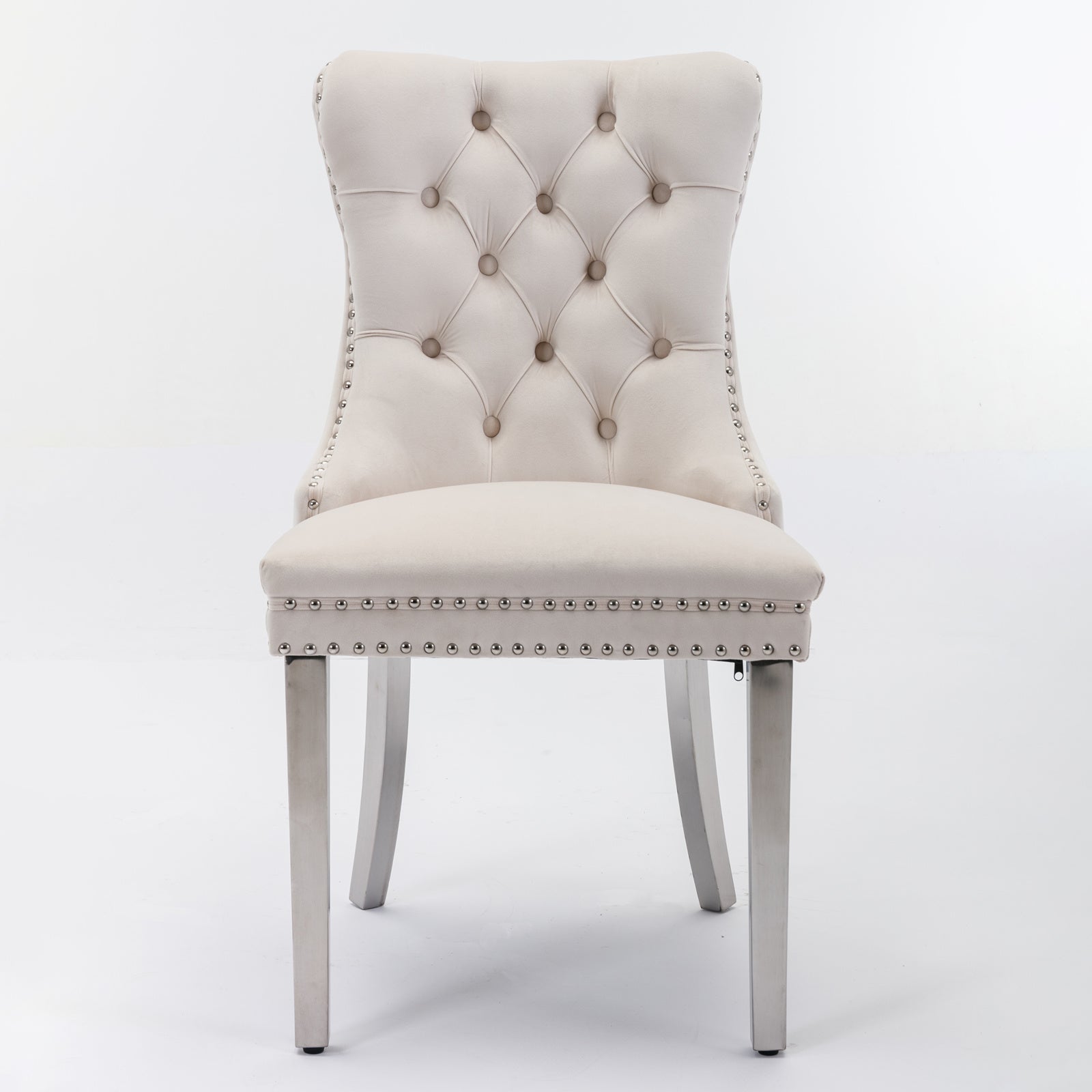 Tufted beige velvet dining chair with silver nailhead trim and metal legs
