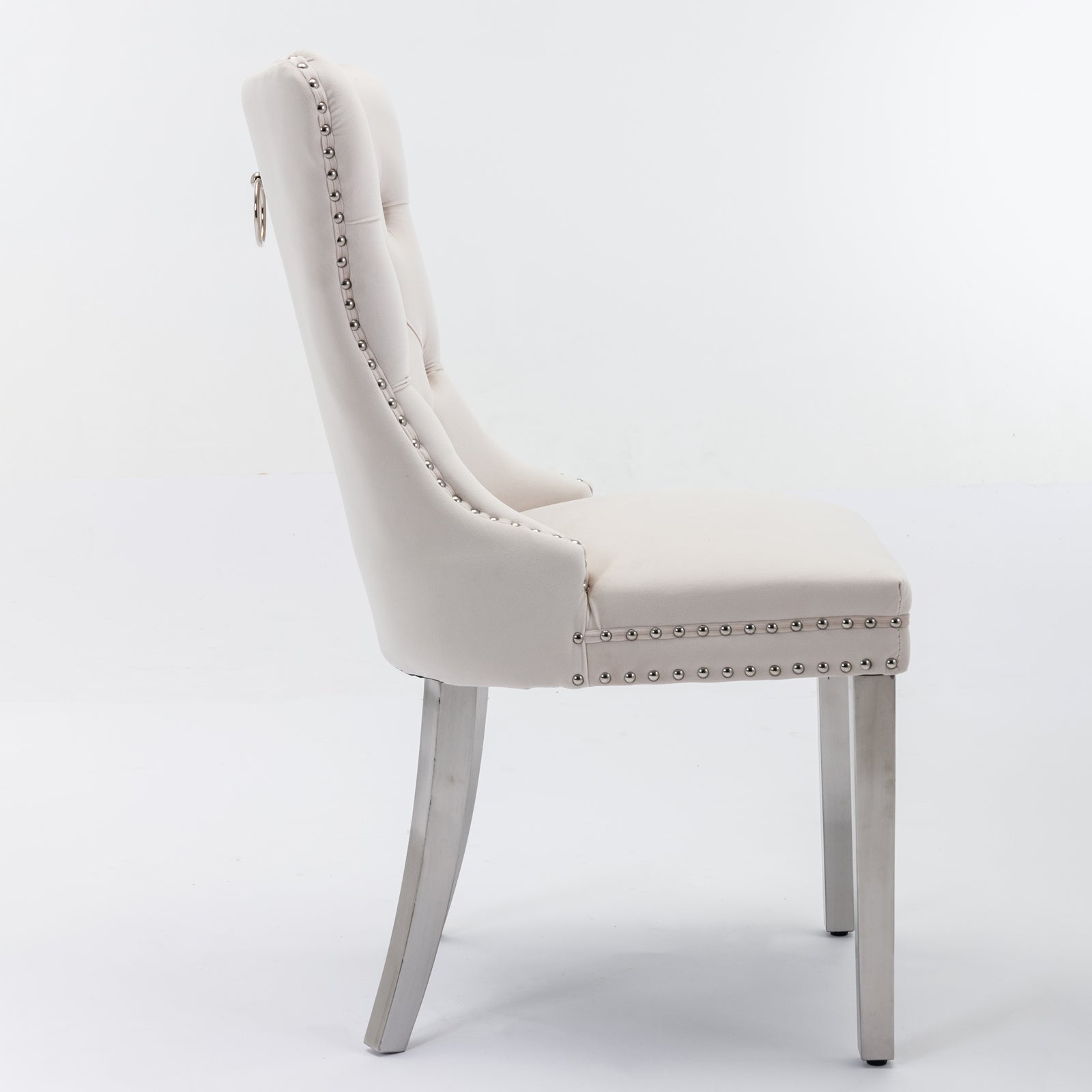 Tufted cream fabric dining chair with silver nailhead trim and ring pull handle