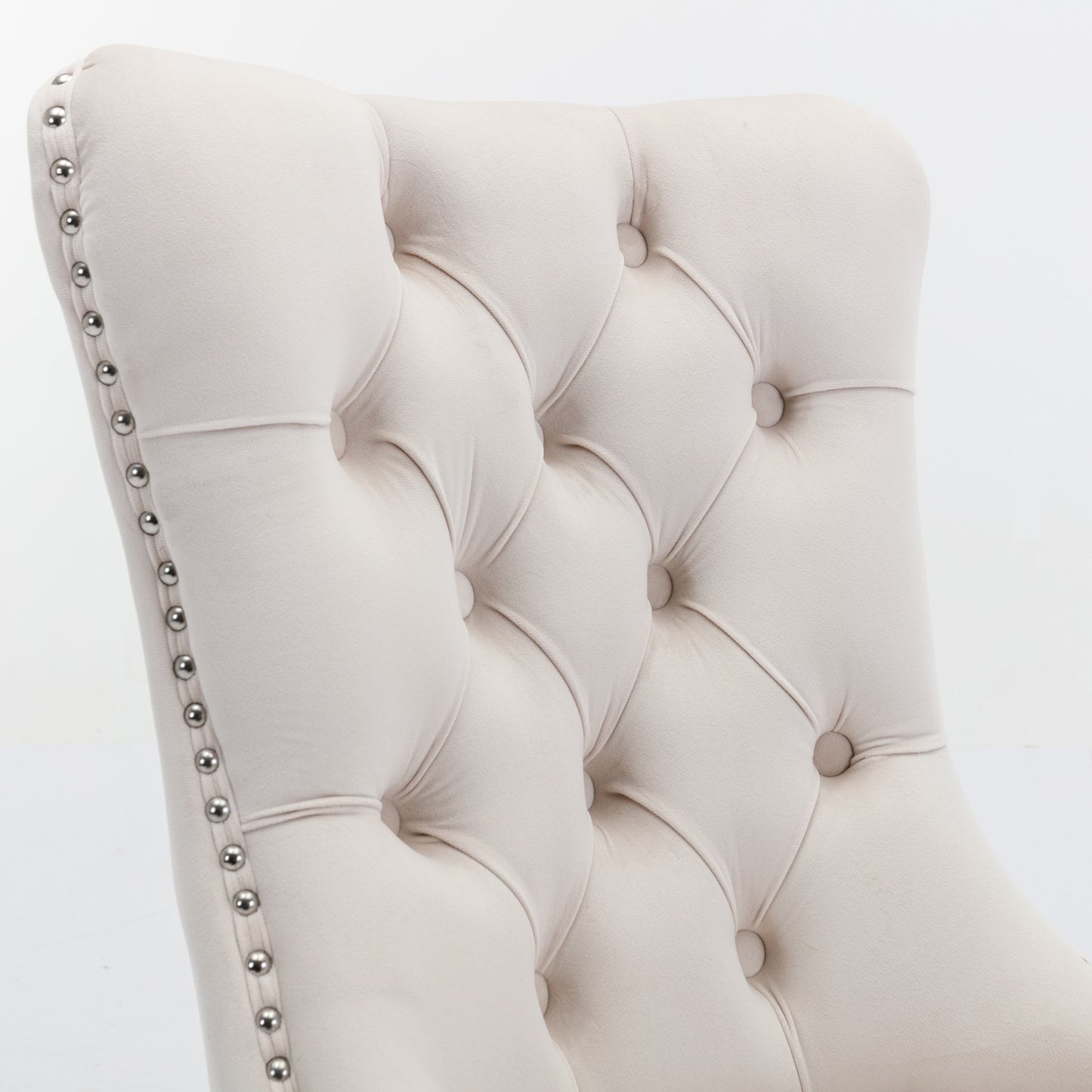 Cream velvet dining chair with button tufting and silver nailhead trim
