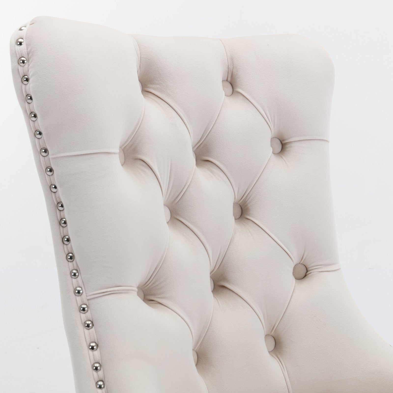 Cream velvet dining chair with button tufting and silver nailhead trim