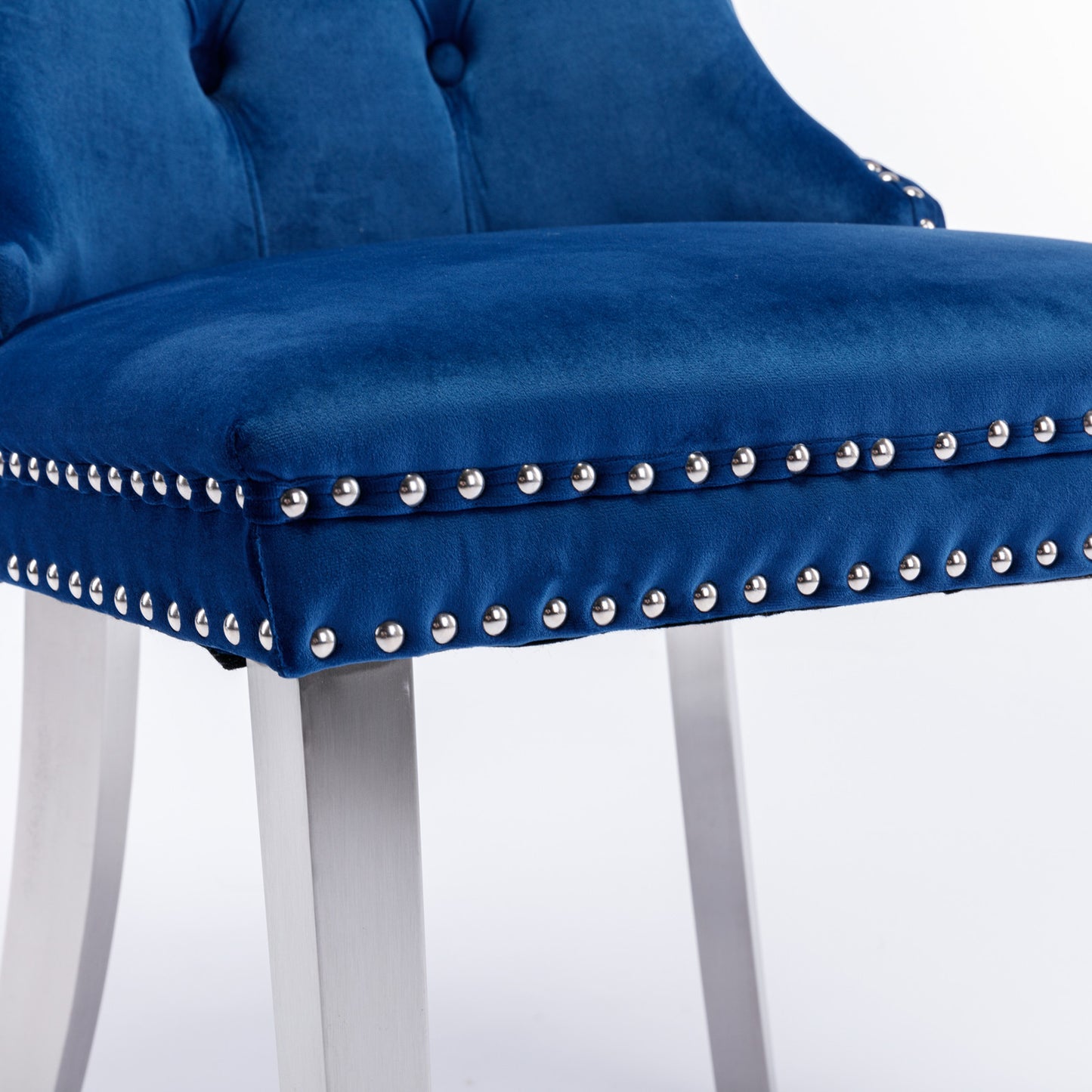 Tufted royal blue velvet bar stool with silver nailhead trim and brushed metal legs