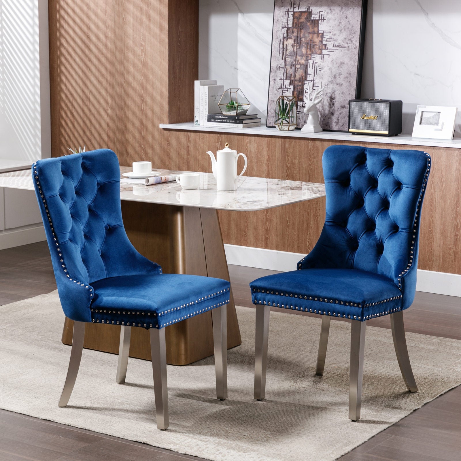 Tufted sapphire velvet dining chair with silver nailhead trim and brushed metal legs