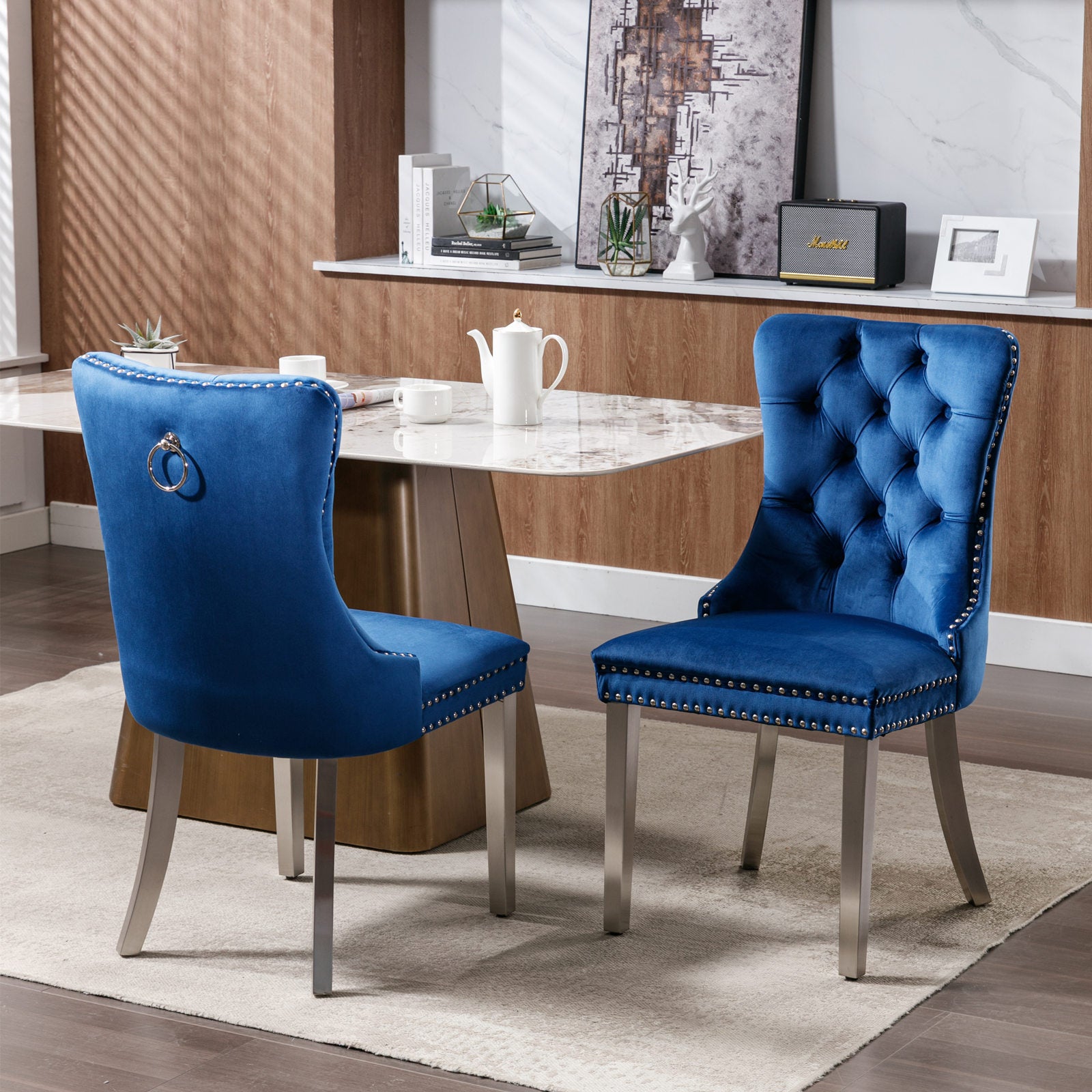Navy blue velvet dining chair with tufted back and silver nailhead trim
