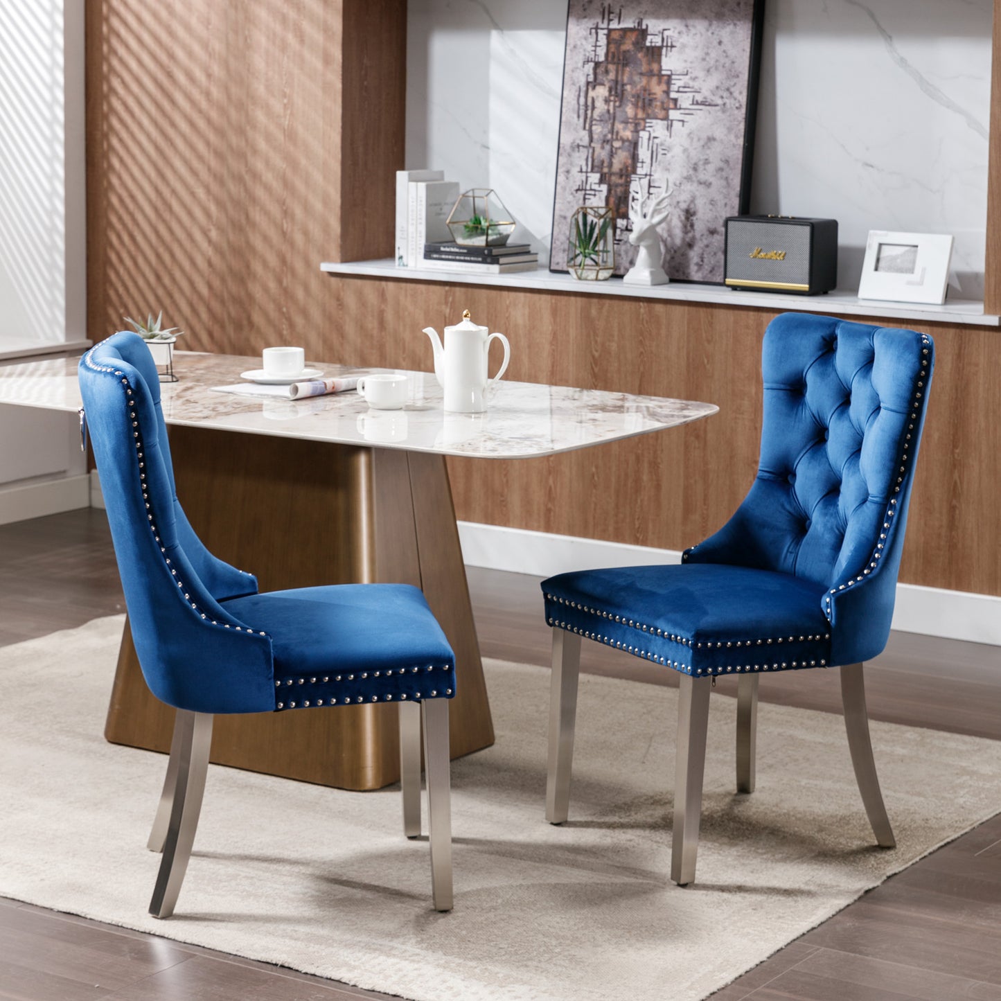 Two navy blue velvet dining chairs with silver nailhead trim