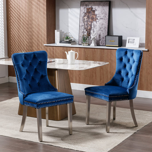 Tufted blue velvet dining chair with silver nailhead trim and metal legs