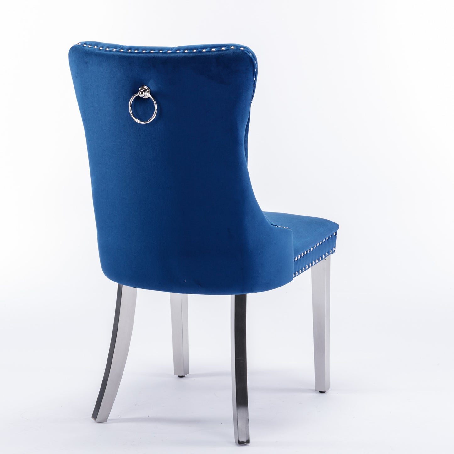 Tufted blue velvet dining chair with silver ring pull on back