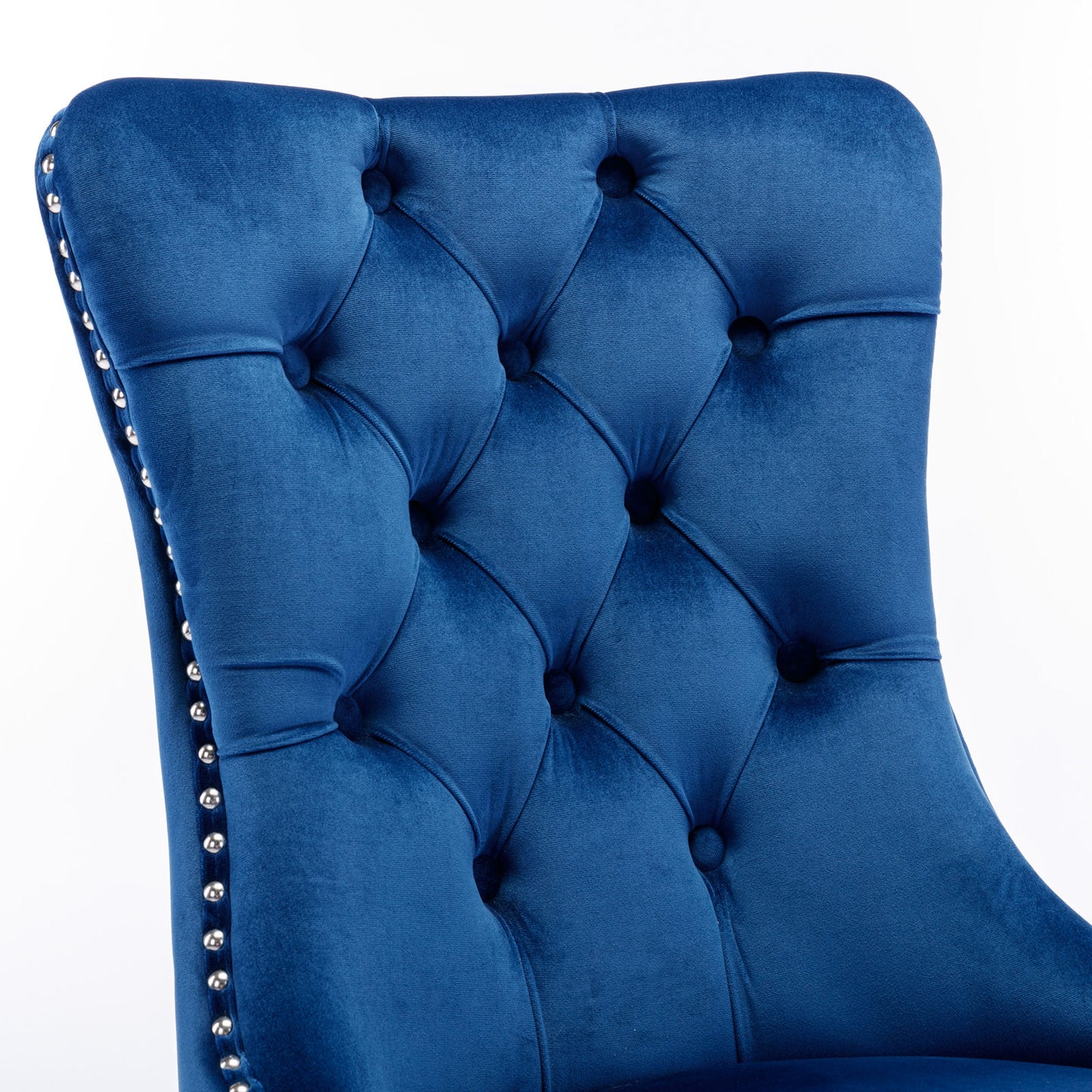 Deep blue velvet dining chair with tufted back and silver nailhead trim