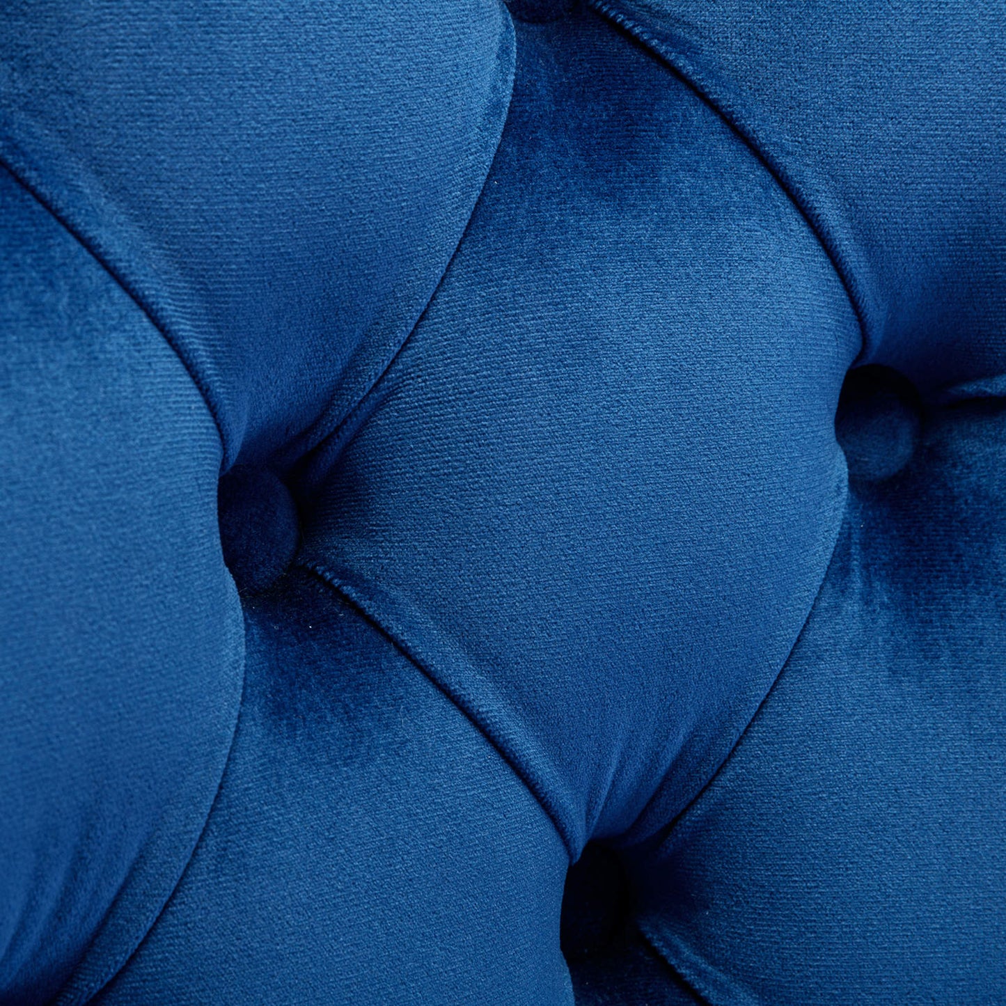 Deep blue velvet tufted sofa detail showing plush texture
