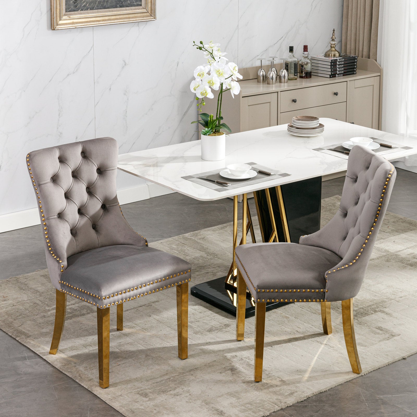Gray velvet tufted dining chair with gold trim and legs
