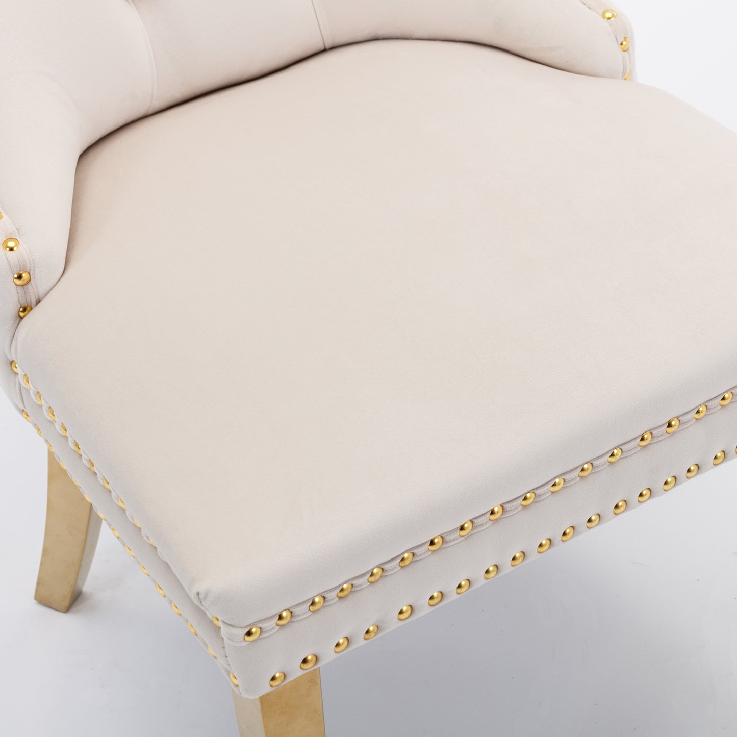 Cream velvet accent chair with gold nailhead trim and tapered wooden legs