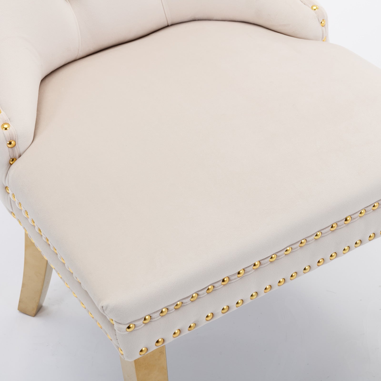 Cream velvet accent chair with gold nailhead trim and tapered wooden legs
