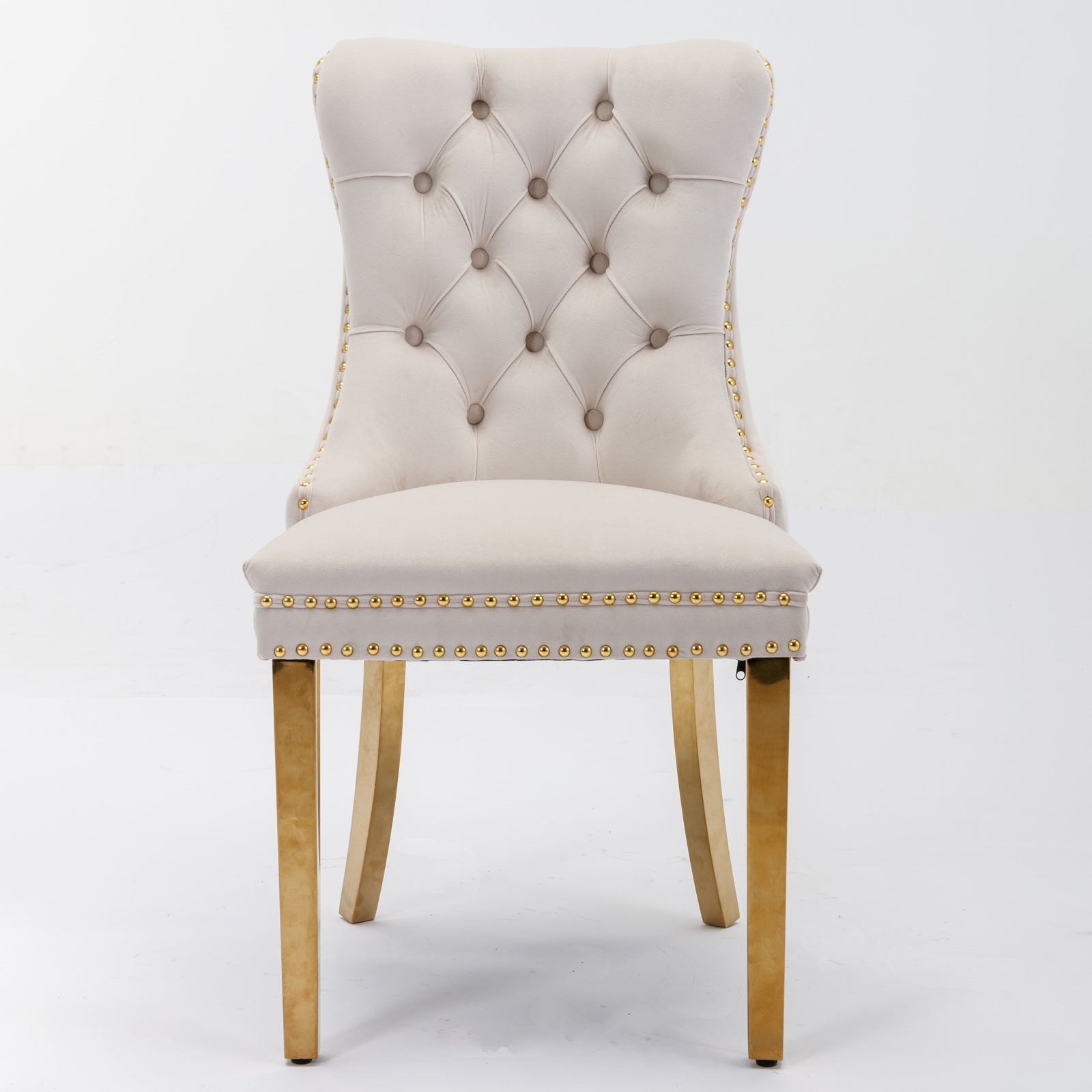 Beige velvet dining chair with tufted back and gold nailhead trim