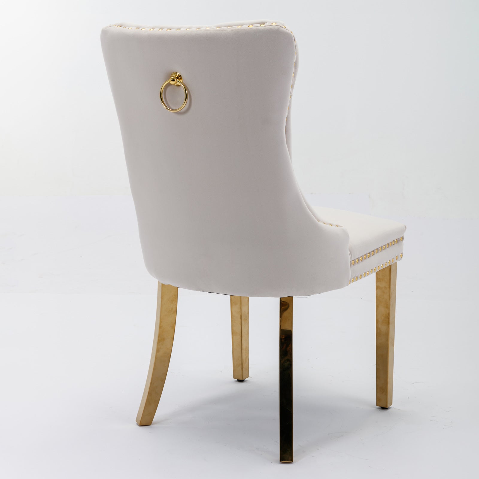 Cream velvet dining chair with gold ring pull and nailhead trim