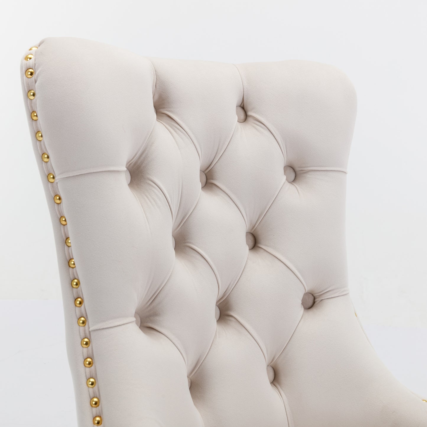 Cream velvet accent chair with diamond tufting and brass nailhead trim