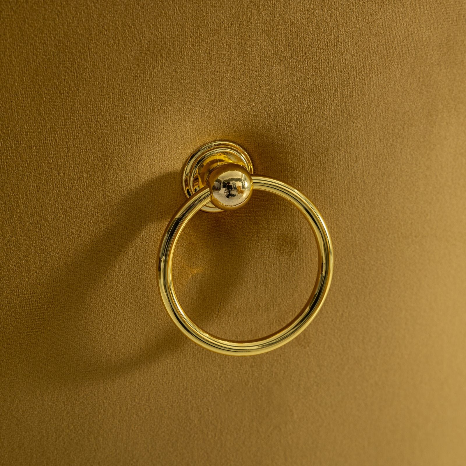 Gold ring pull on mustard velvet cushion