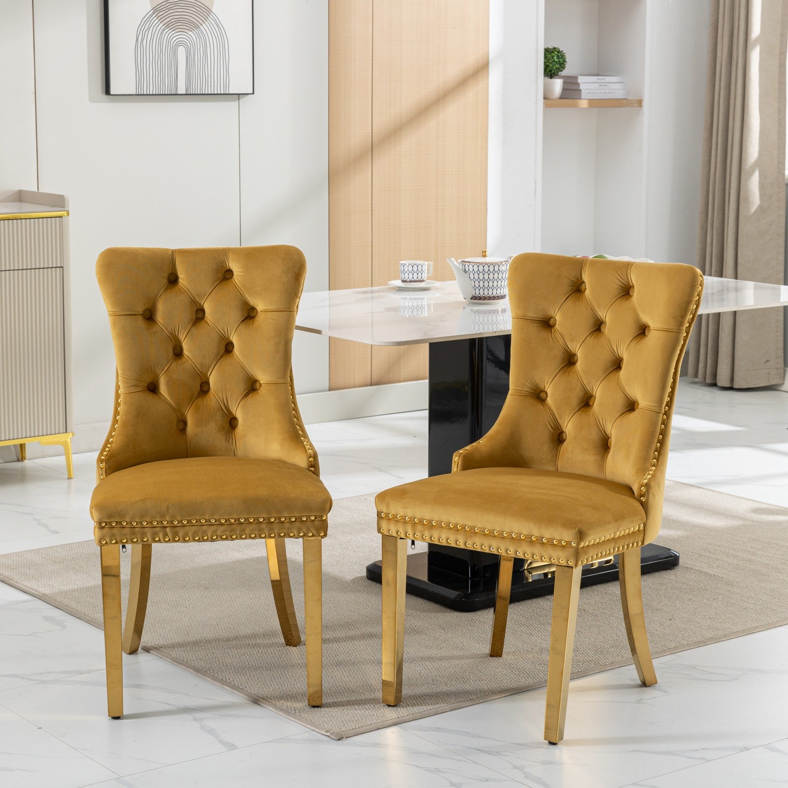 Golden velvet tufted dining chair with nailhead trim and gold legs