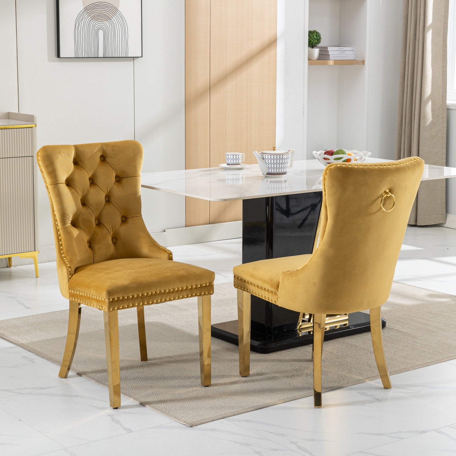 Tufted gold velvet dining chair with gold nailhead trim and gold legs