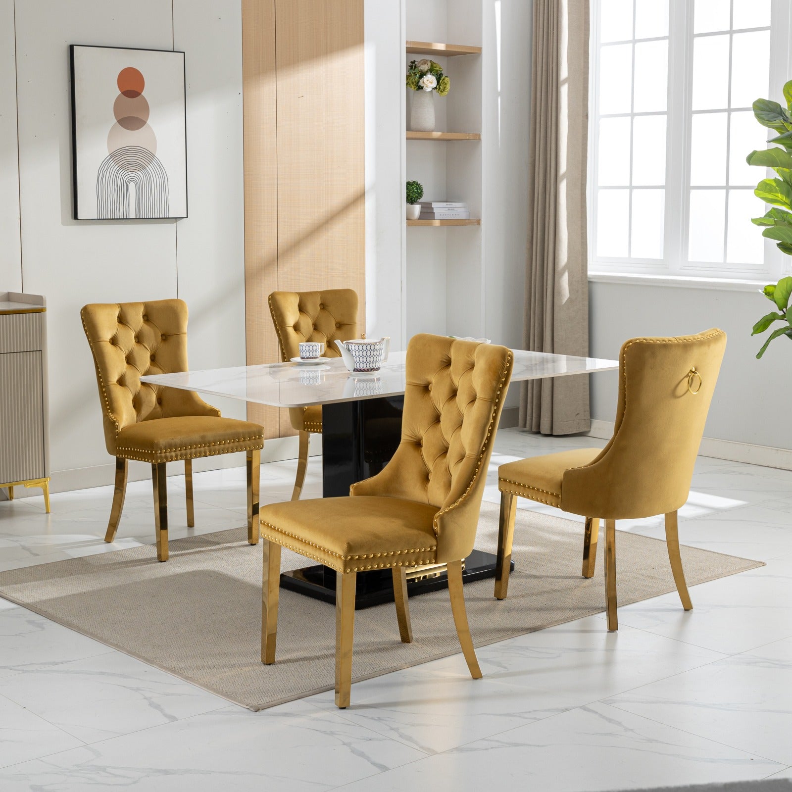 Yellow velvet dining chairs with gold legs and nailhead trim