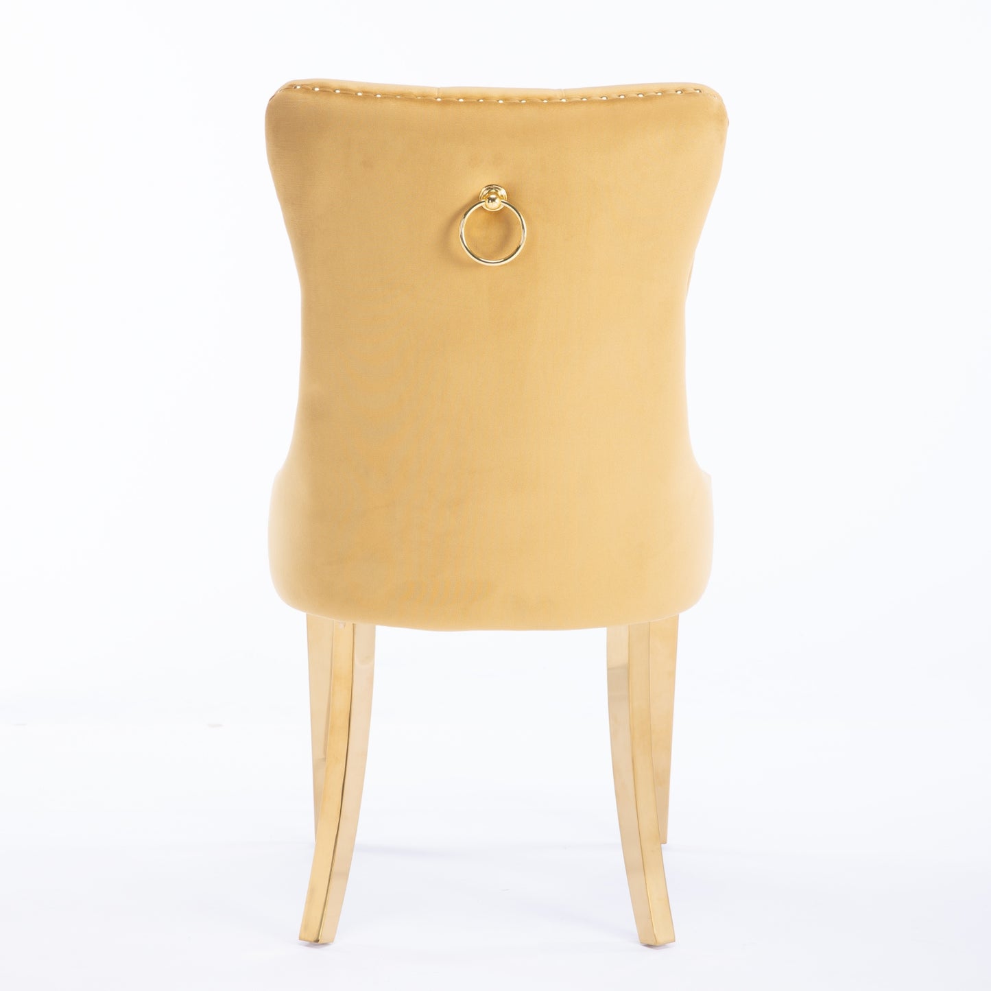 Luxurious mustard velvet dining chair with a gold ring pull and tufted back