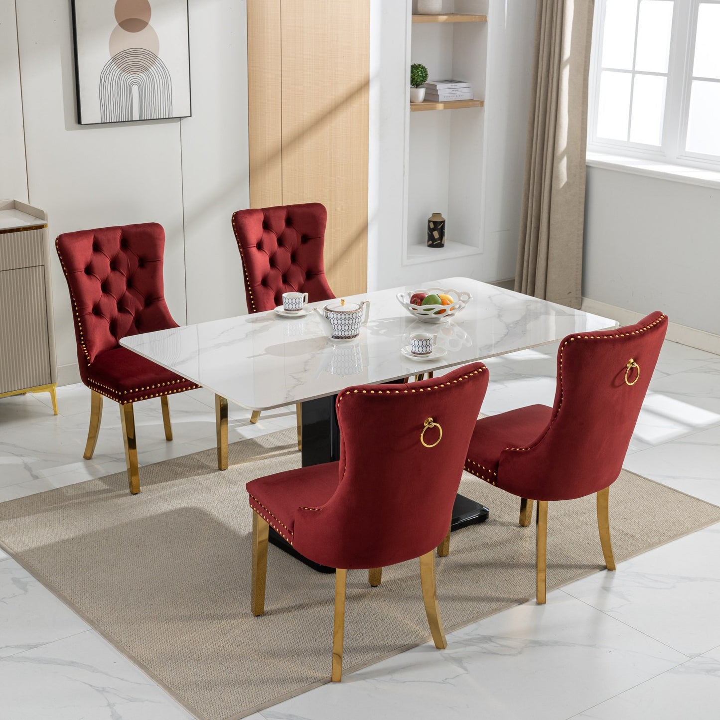 Red velvet dining chair with gold ring pull and nailhead trim