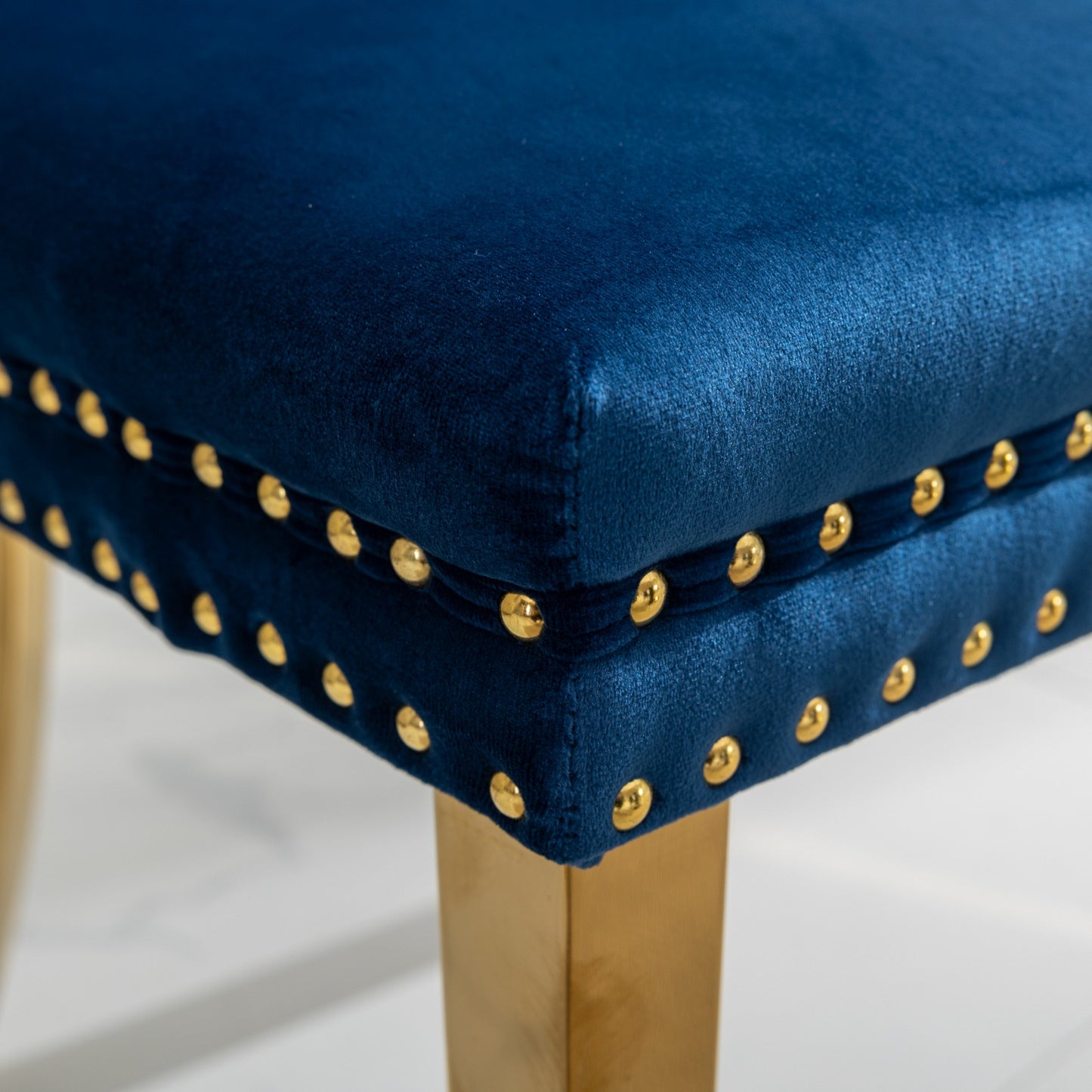 Navy blue velvet accent chair with gold nailhead trim