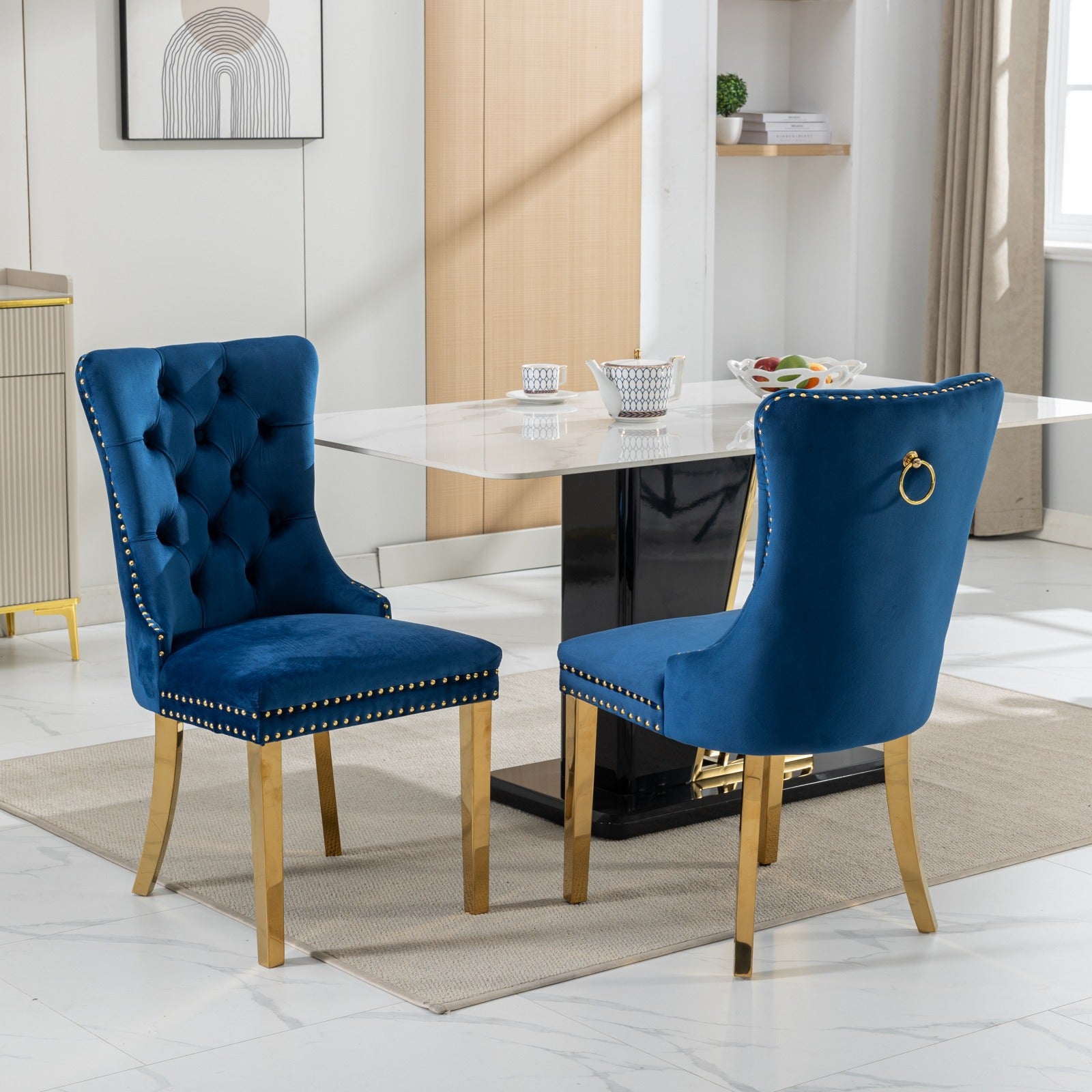 Tufted navy velvet dining chair with gold legs and decorative nailhead trim