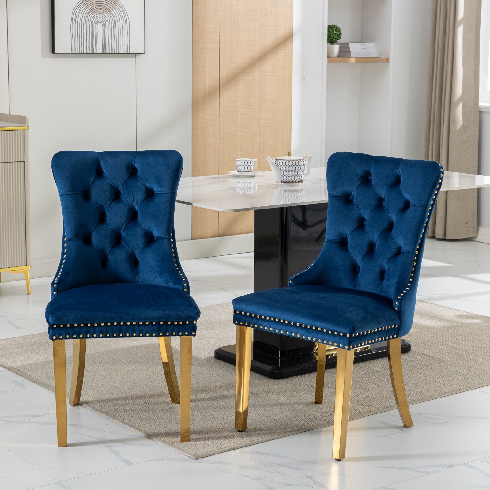 Tufted navy velvet dining chair with gold nailhead trim and gold legs