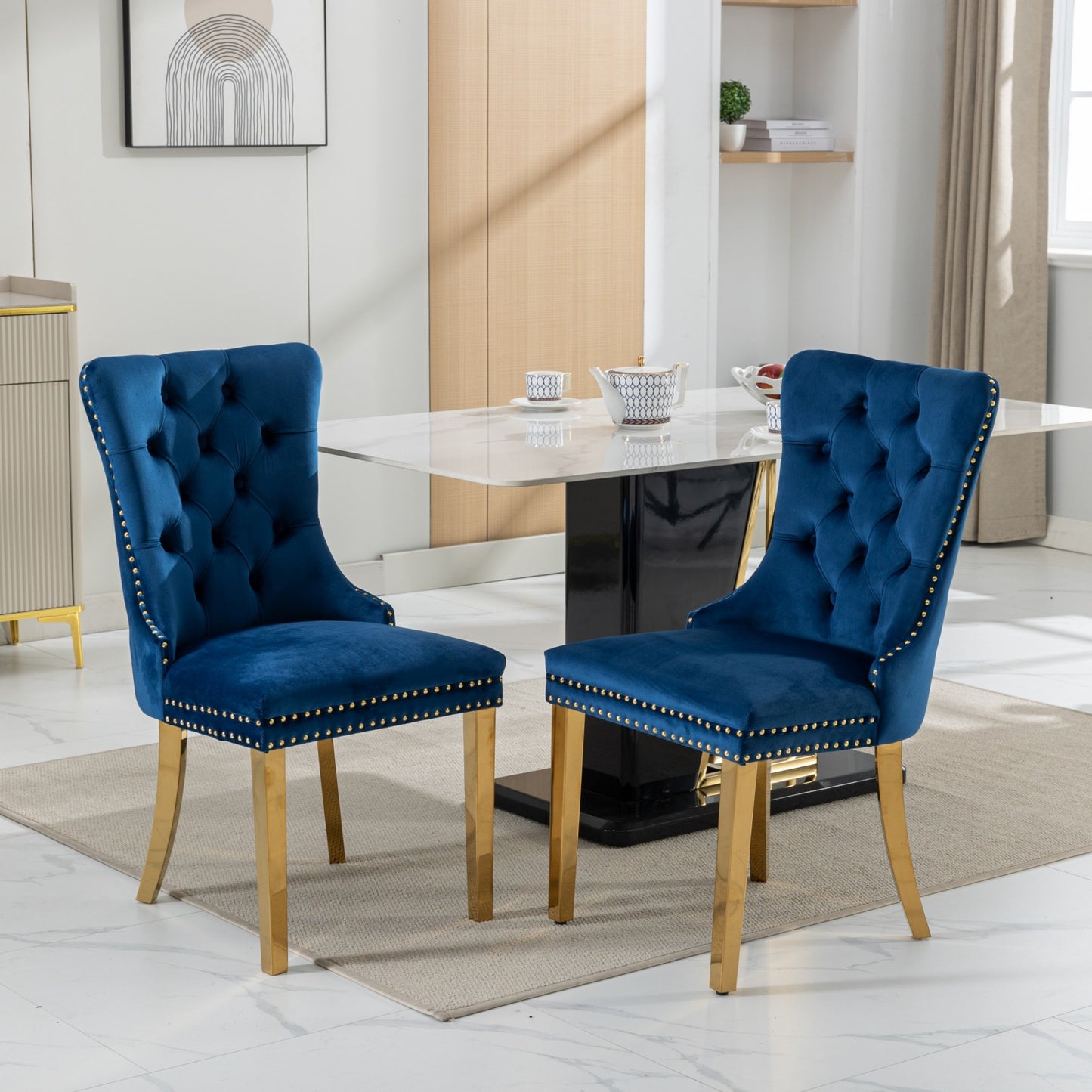 Deep blue velvet dining chair with gold nailhead trim and brass legs