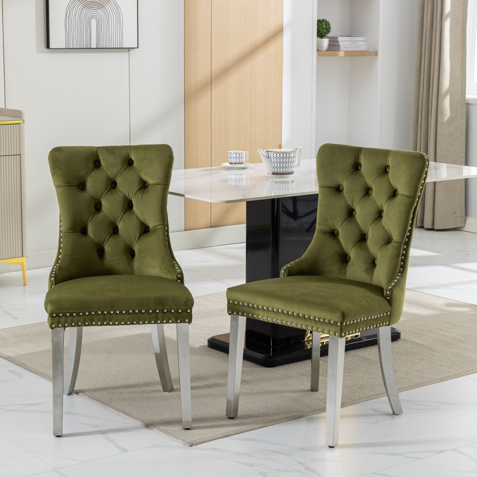 Green velvet tufted dining chair with silver nailhead trim and brushed steel legs