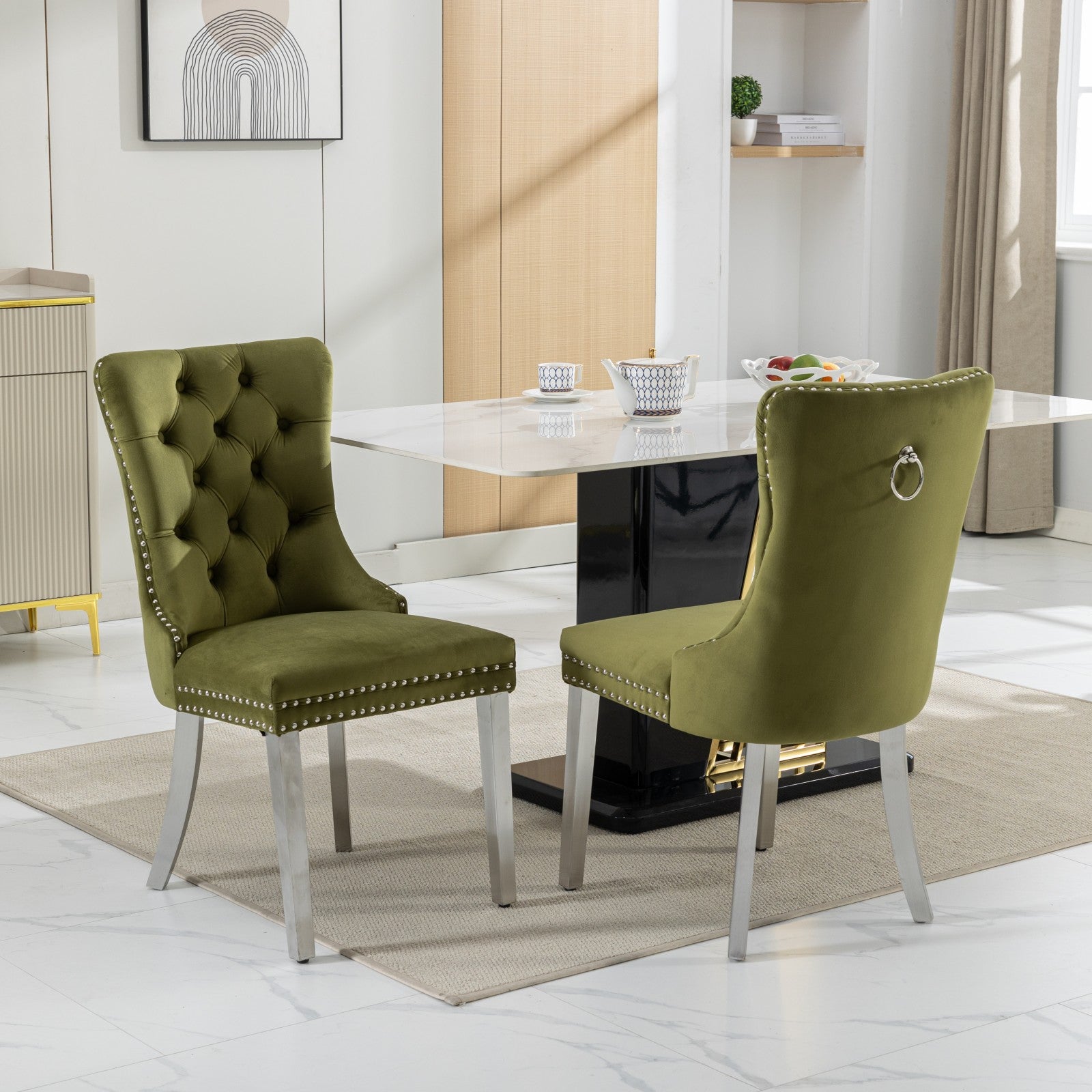 Emerald green velvet dining chair with tufted back and silver nailhead trim