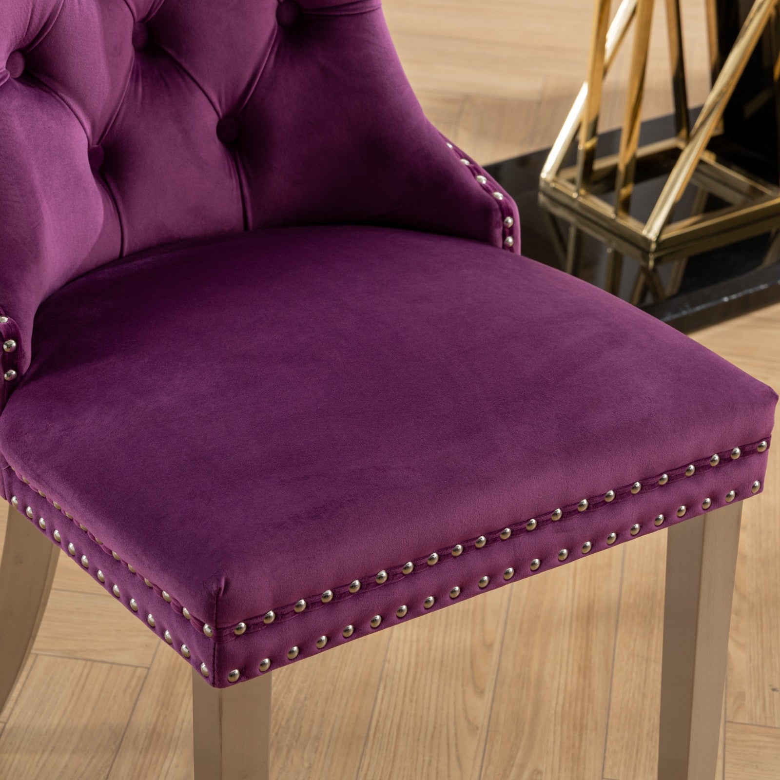 Plush purple velvet armchair with tufted back and nailhead trim