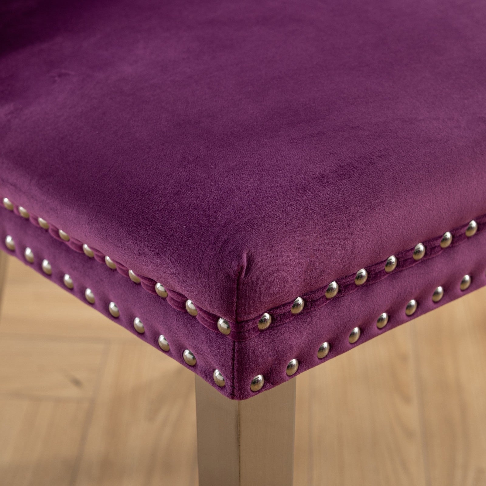 Plush purple velvet stool with silver nailhead trim detail