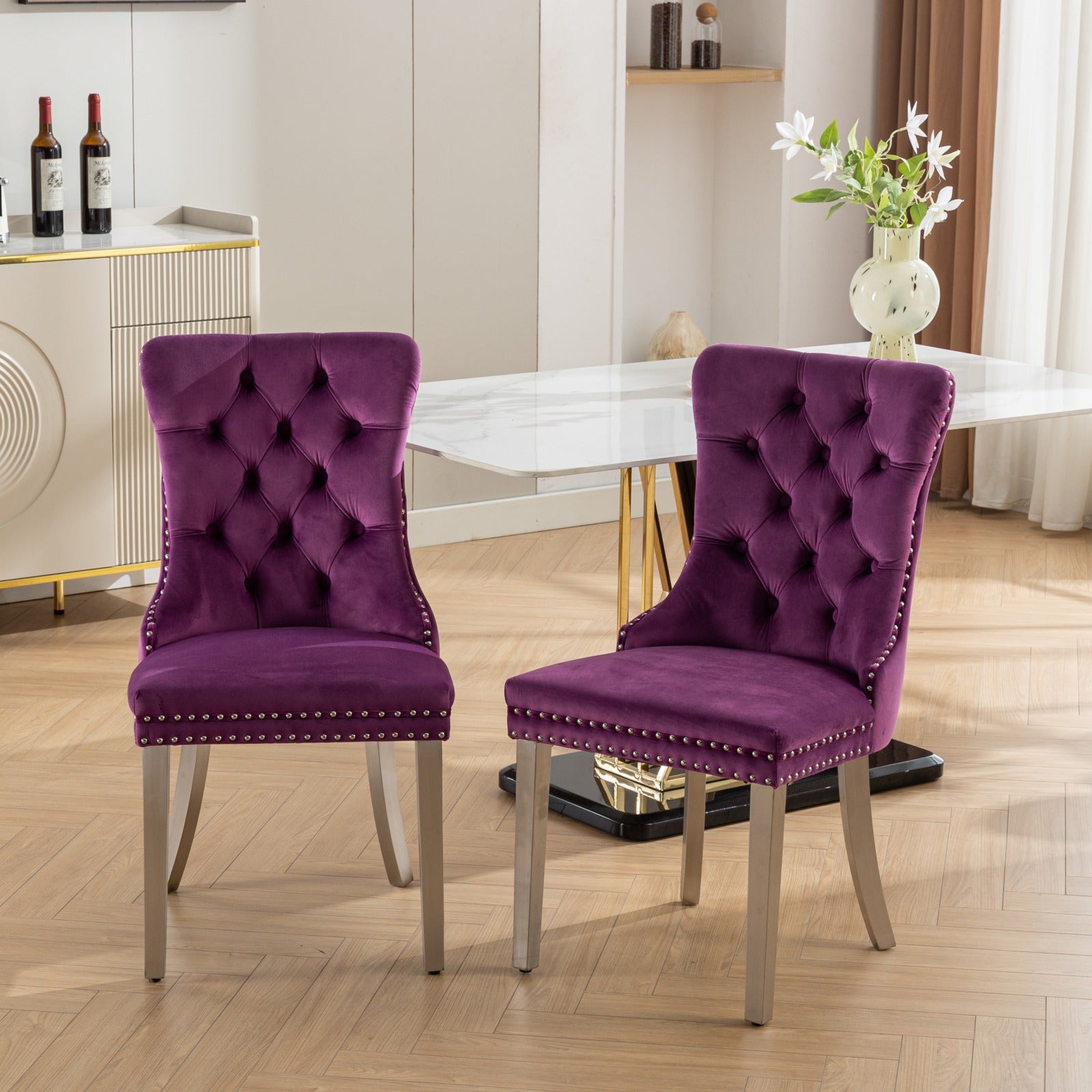 Plush purple velvet tufted dining chair with silver nailhead trim and silver legs