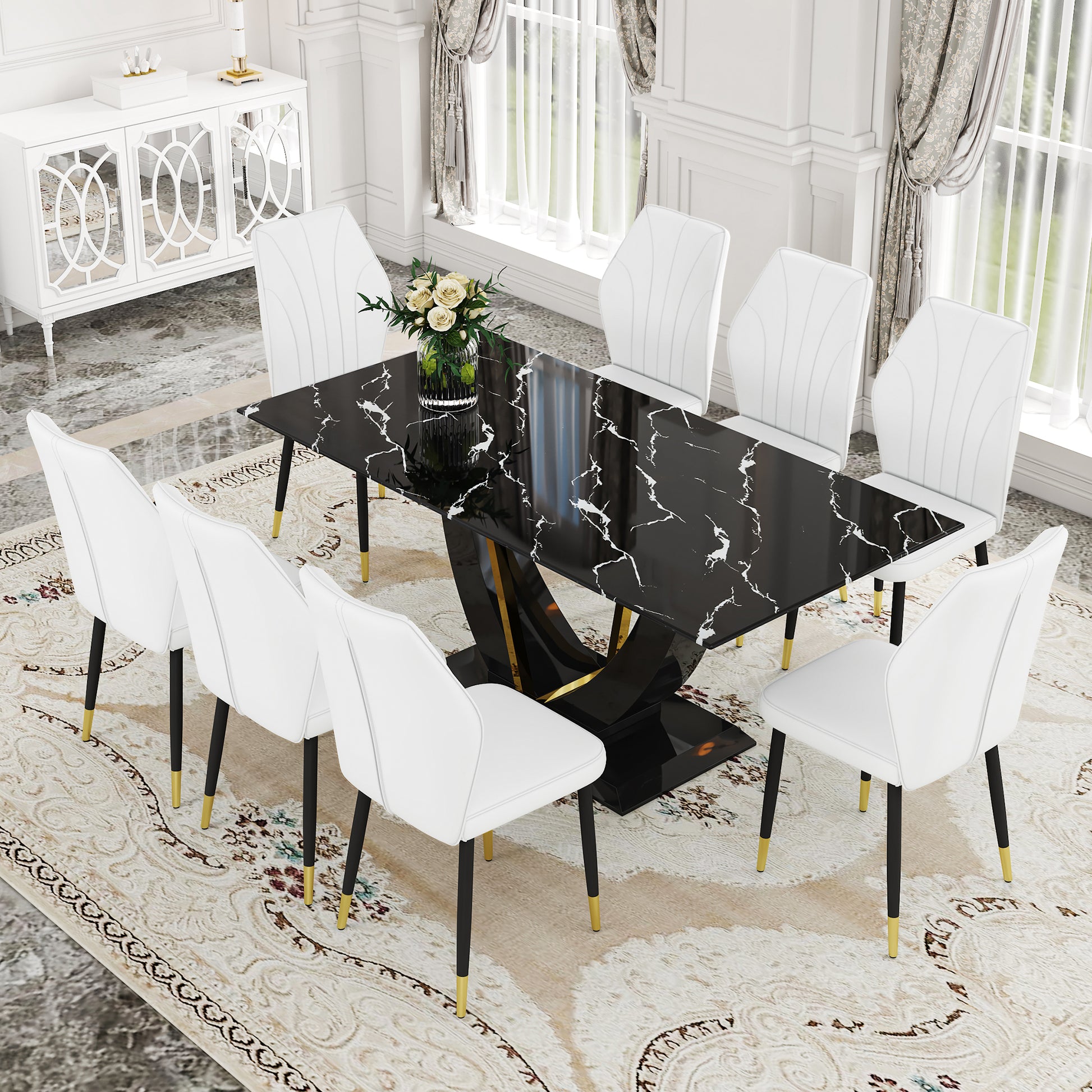 Black marble dining table with pedestal base and  white upholstered chairs