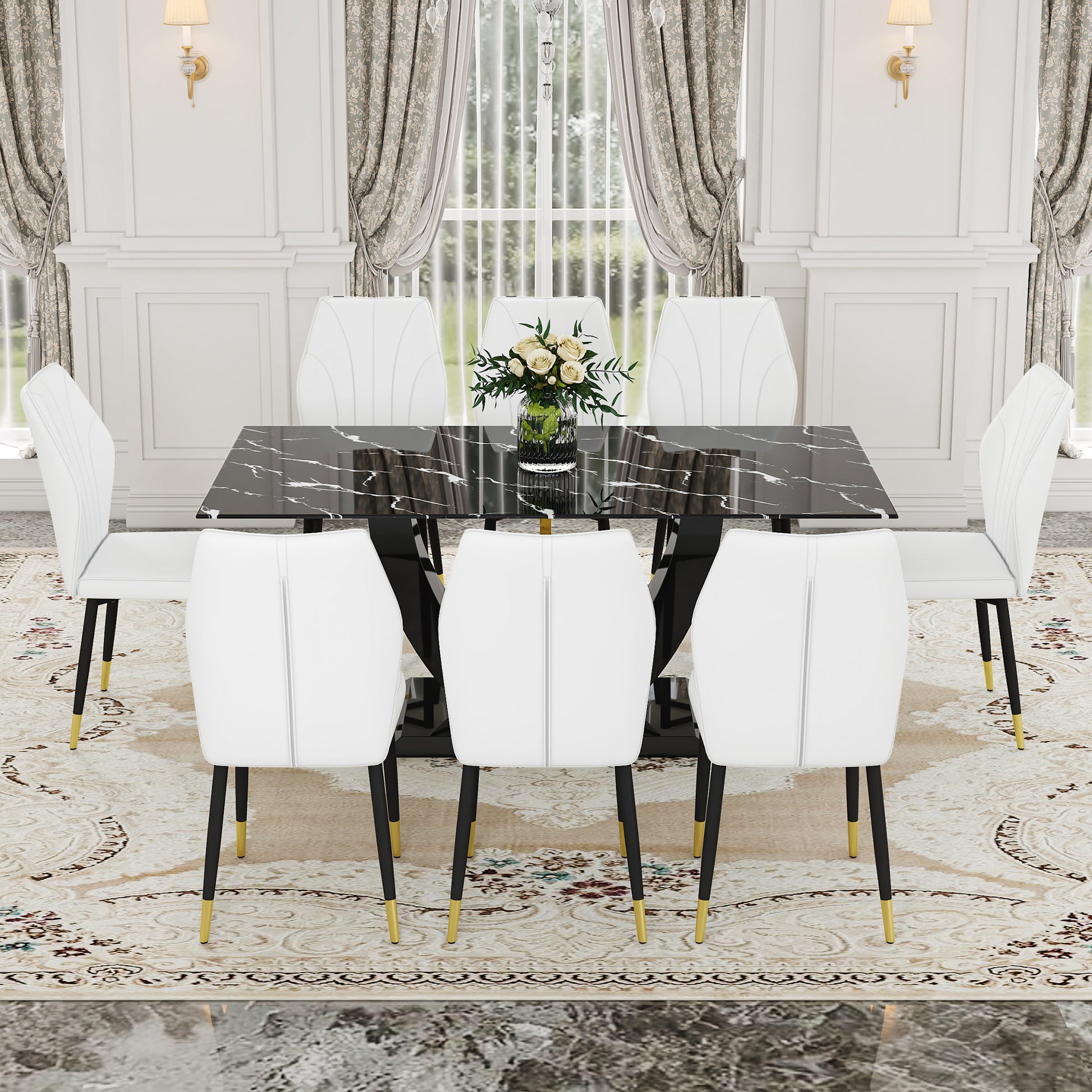 Black marble top dining table with white chairs and gold accents