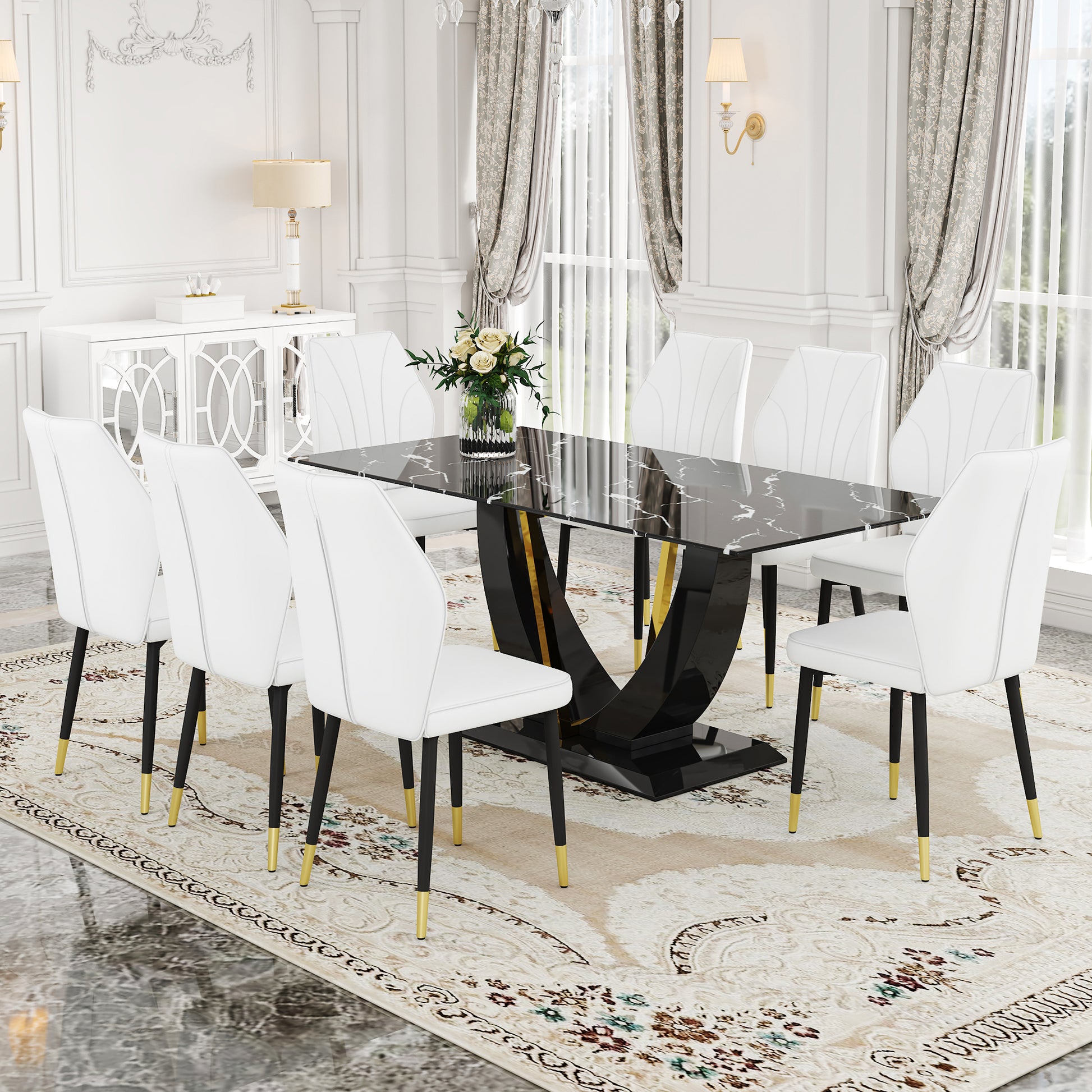 Modern black marble dining table with gold accents and eight white upholstered chairs