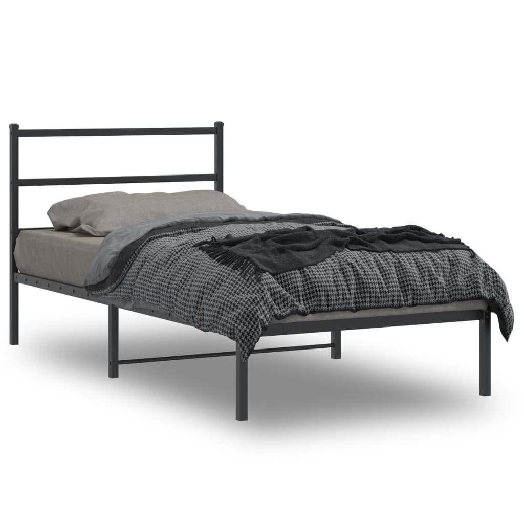 Dark gray metal bed frame with simple horizontal headboard and footboard dressed with gray bedding