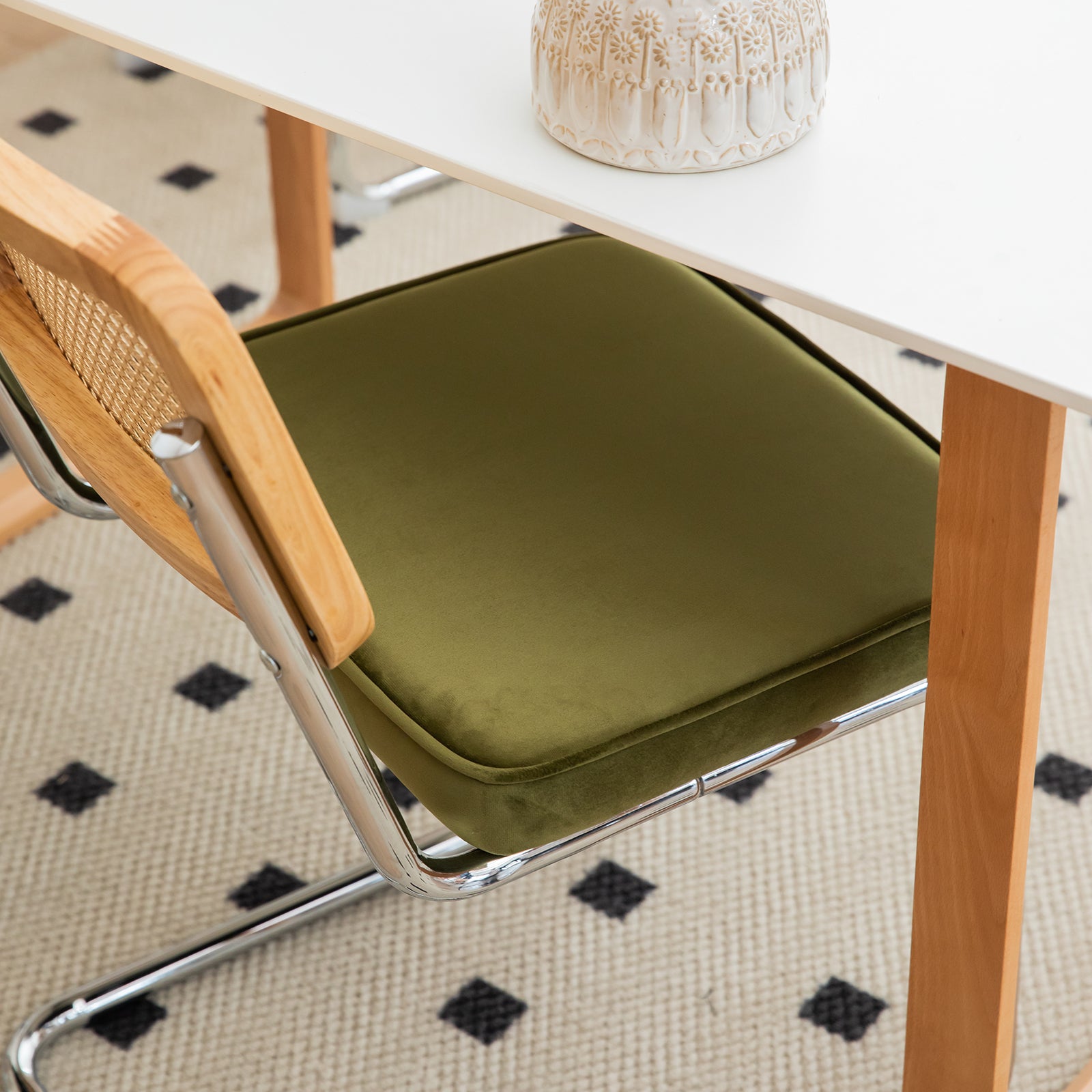 Green velvet accent chair with natural wood and chrome frame
